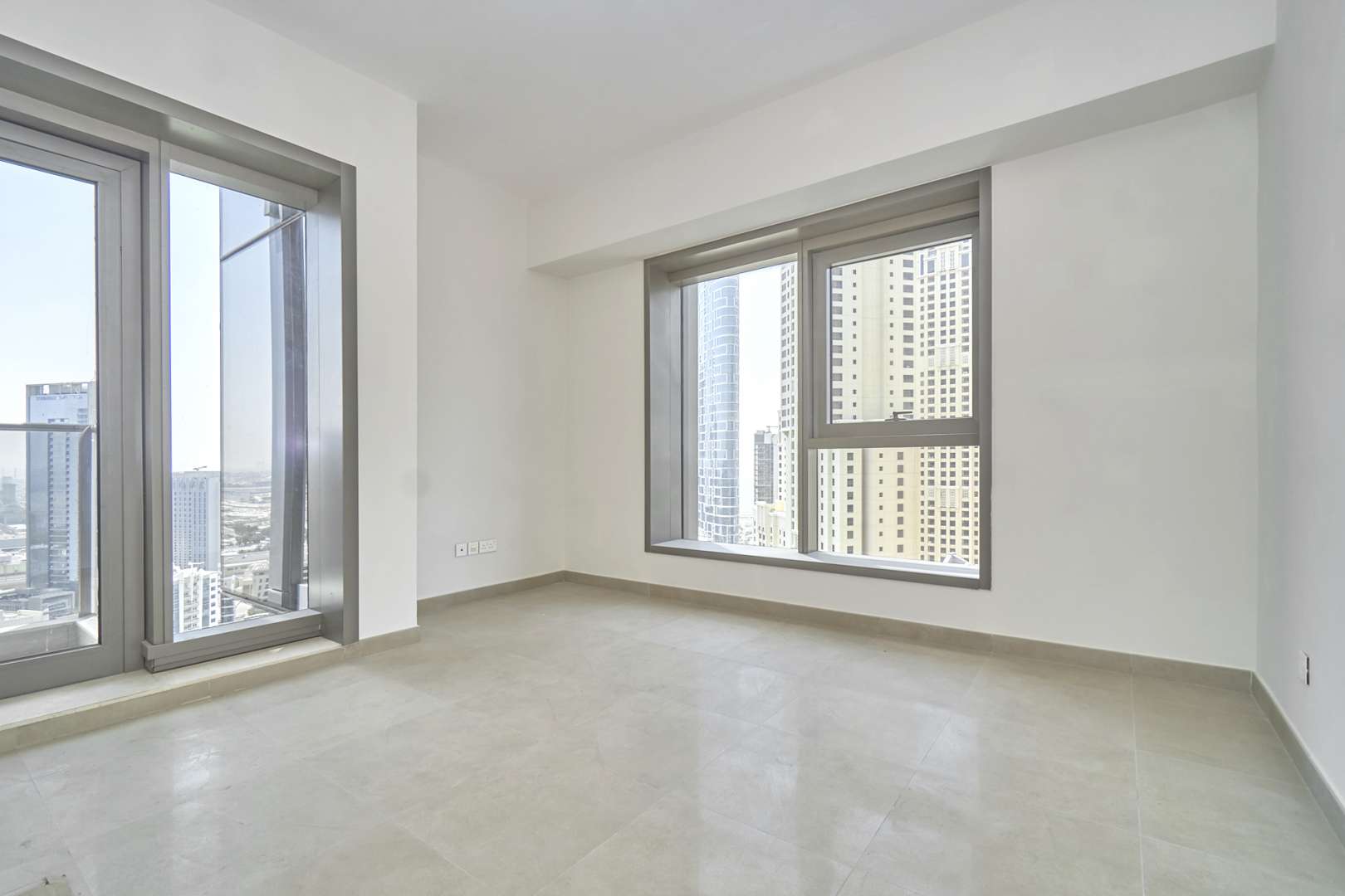 Empty room with large windows and marina view in Sparkle Towers, Dubai Marina