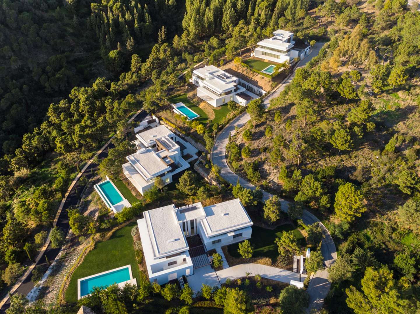 Aerial view of luxury villas in La Reserva de Alcuzcuz, Benahavis, Marbella mountains