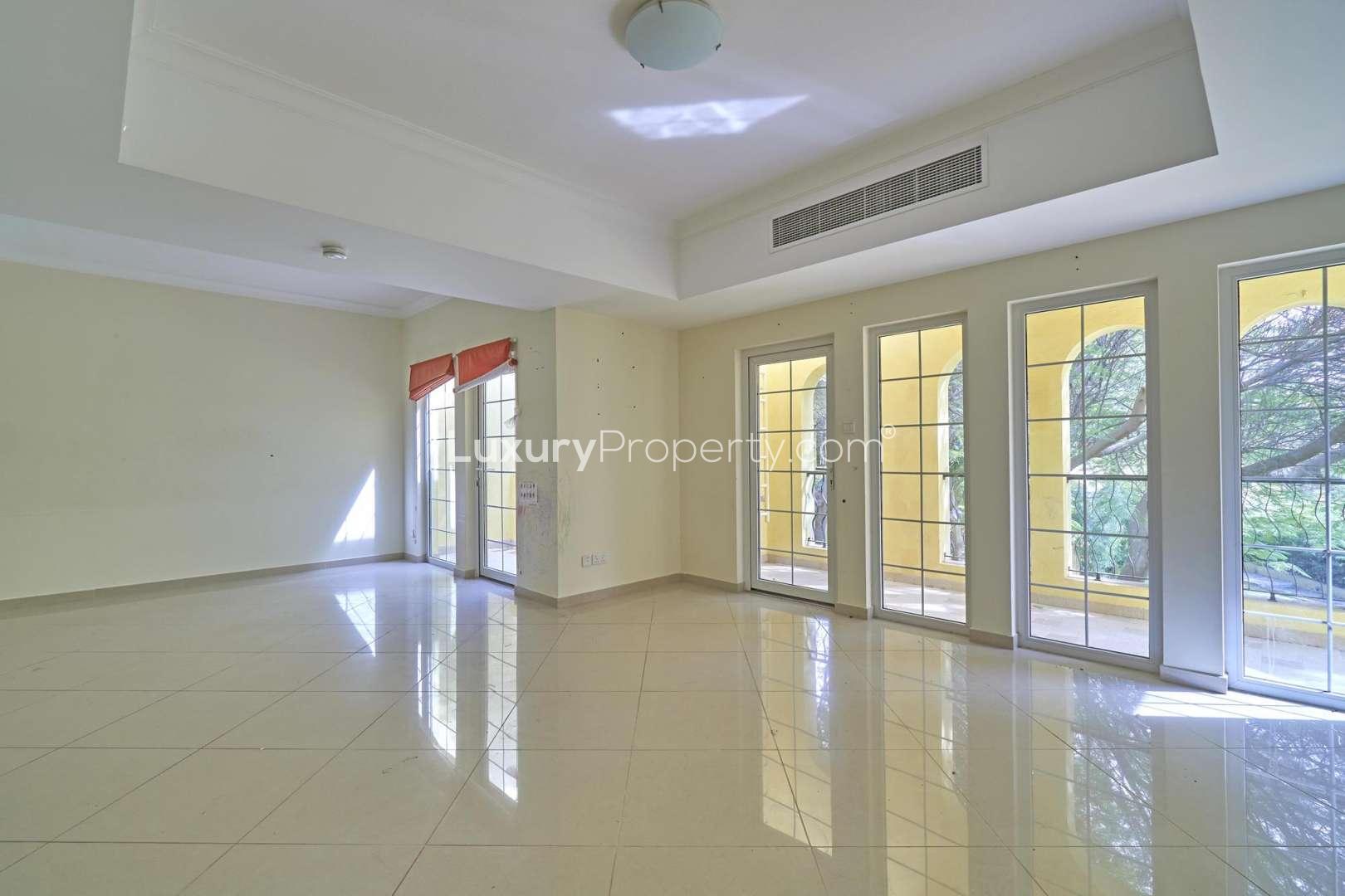 Spacious living area with large windows in Layan Community townhouse, Dubai Land