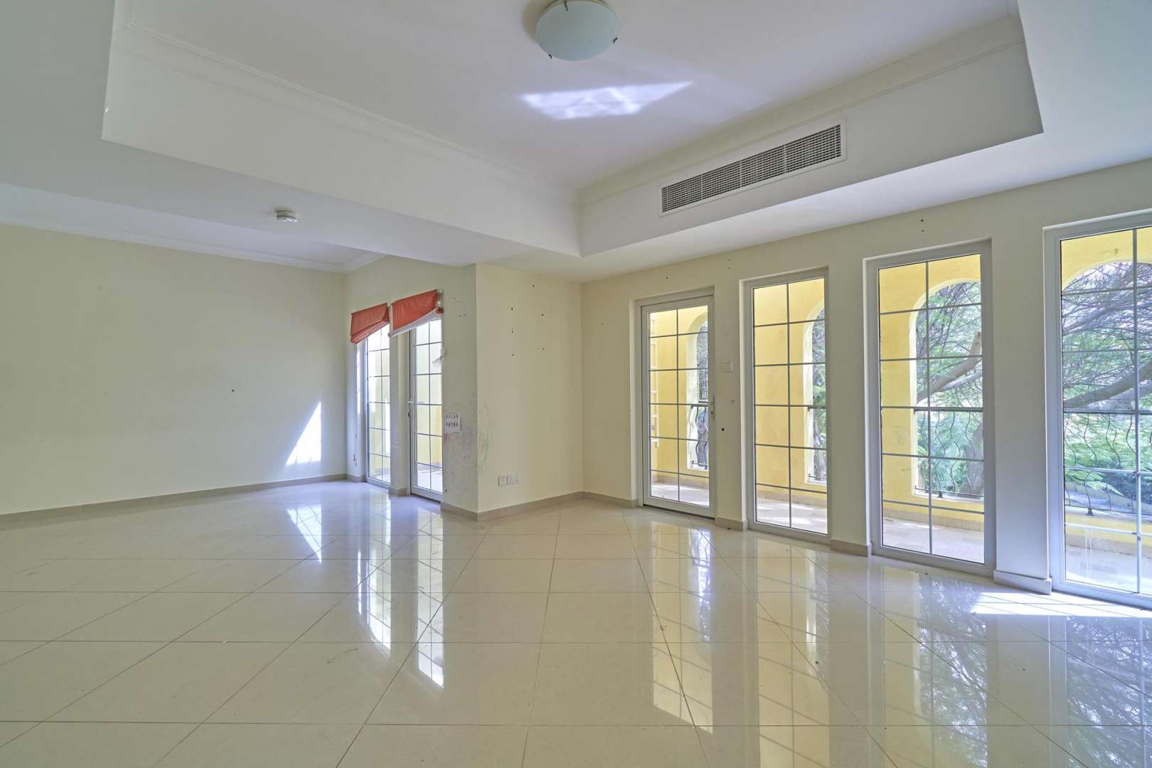 Spacious living area with large windows in Layan Community townhouse, Dubai Land