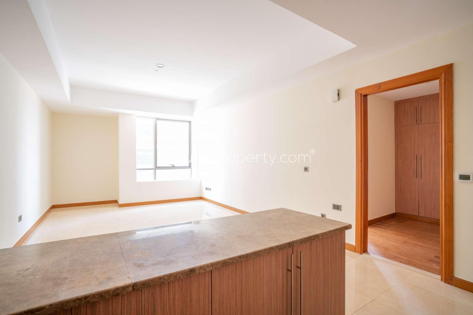 Spacious bedroom with wooden flooring and built-in wardrobe in Al Murad Tower apartment