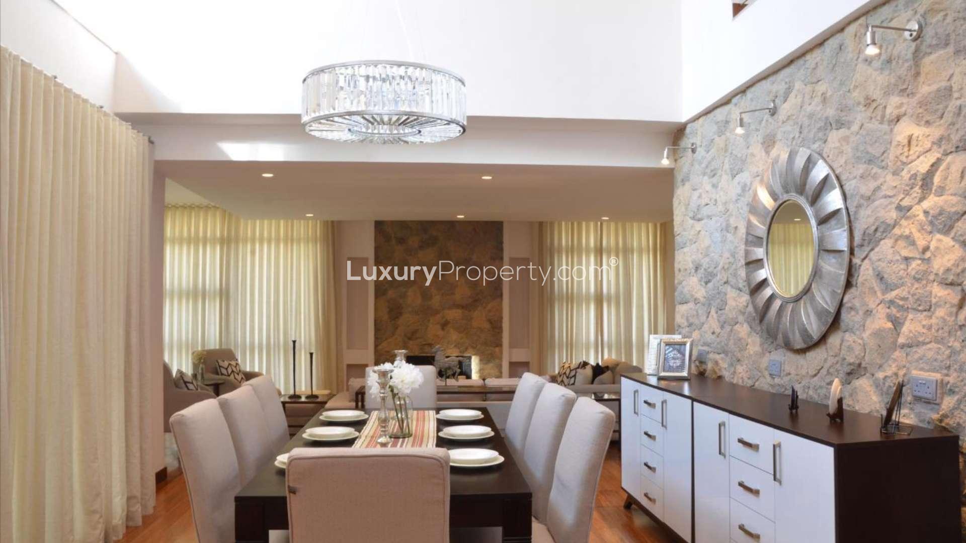 Modern five-bedroom villa exterior at dusk in Karen, Nairobi, surrounded by lush greenery