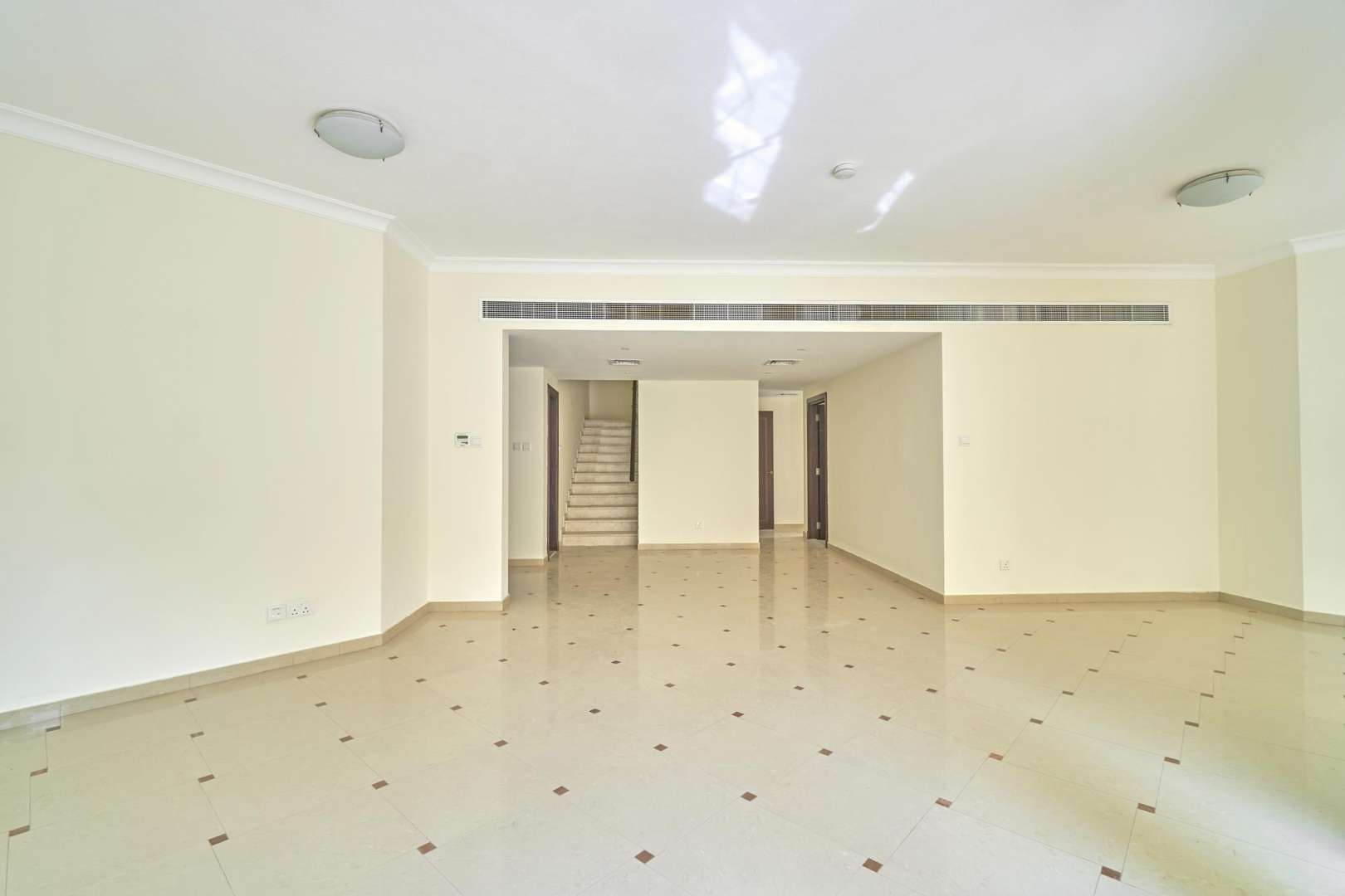 Spacious living area with large windows in Layan Community townhouse, Dubai for rent