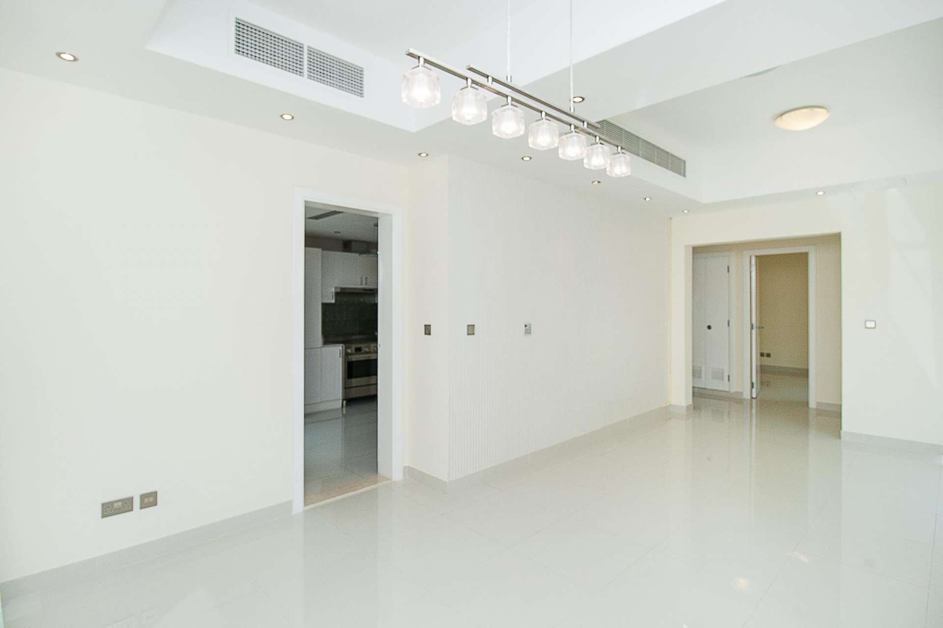 Upgraded villa interior with wooden flooring and white staircase in Maeen, The Lakes