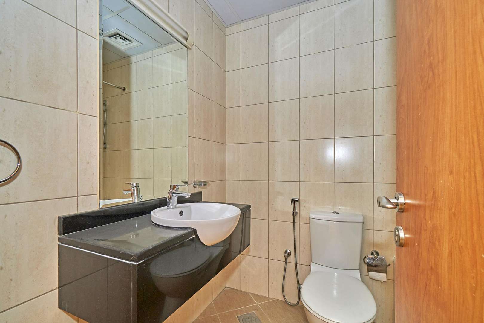 Empty room with tiled floor and large window in Emirates Garden apartment, JVC