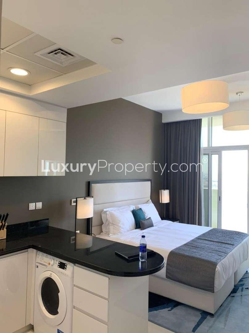 Studio apartment interior with modern kitchen and bed, Al Barsha, Jumeirah Village Circle