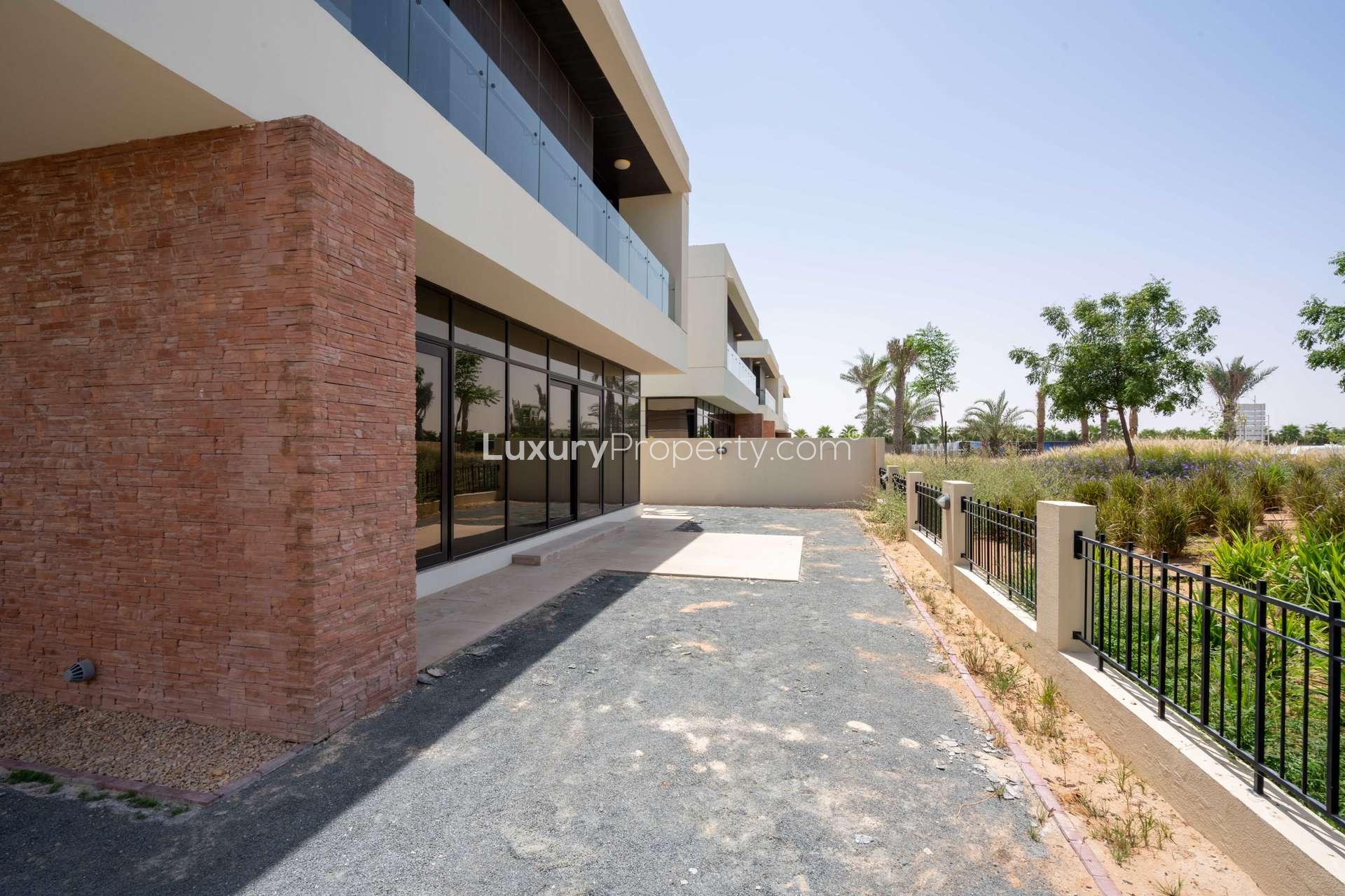 Modern kitchen in 5-bedroom villa for rent, Richmond, Damac Hills, featuring sleek countertops