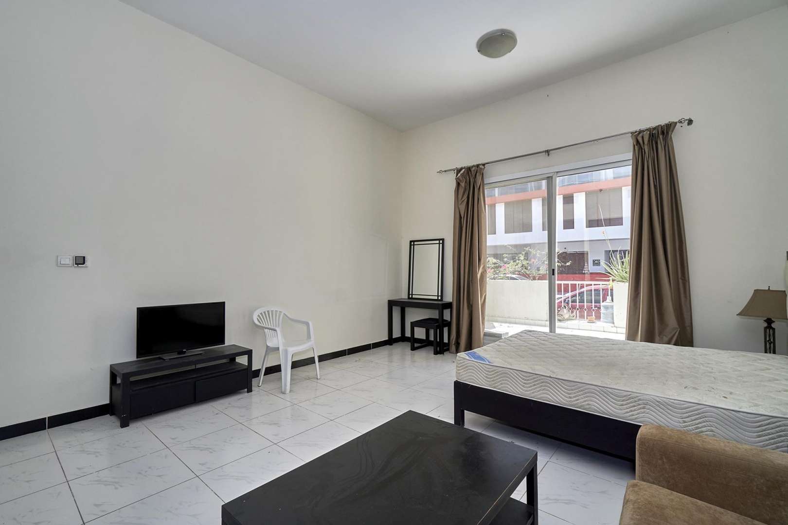 Street view of Knightsbridge Court, JVC, showing nearby buildings and urban landscape