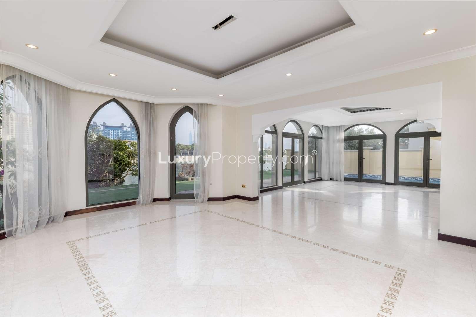 Exterior of 4-bedroom villa in Palm Jumeirah, garden view, arched windows, patio area