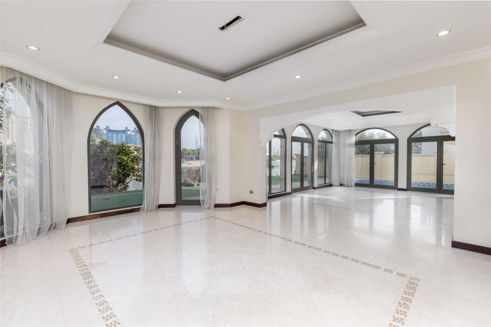 Exterior of 4-bedroom villa in Palm Jumeirah, garden view, arched windows, patio area