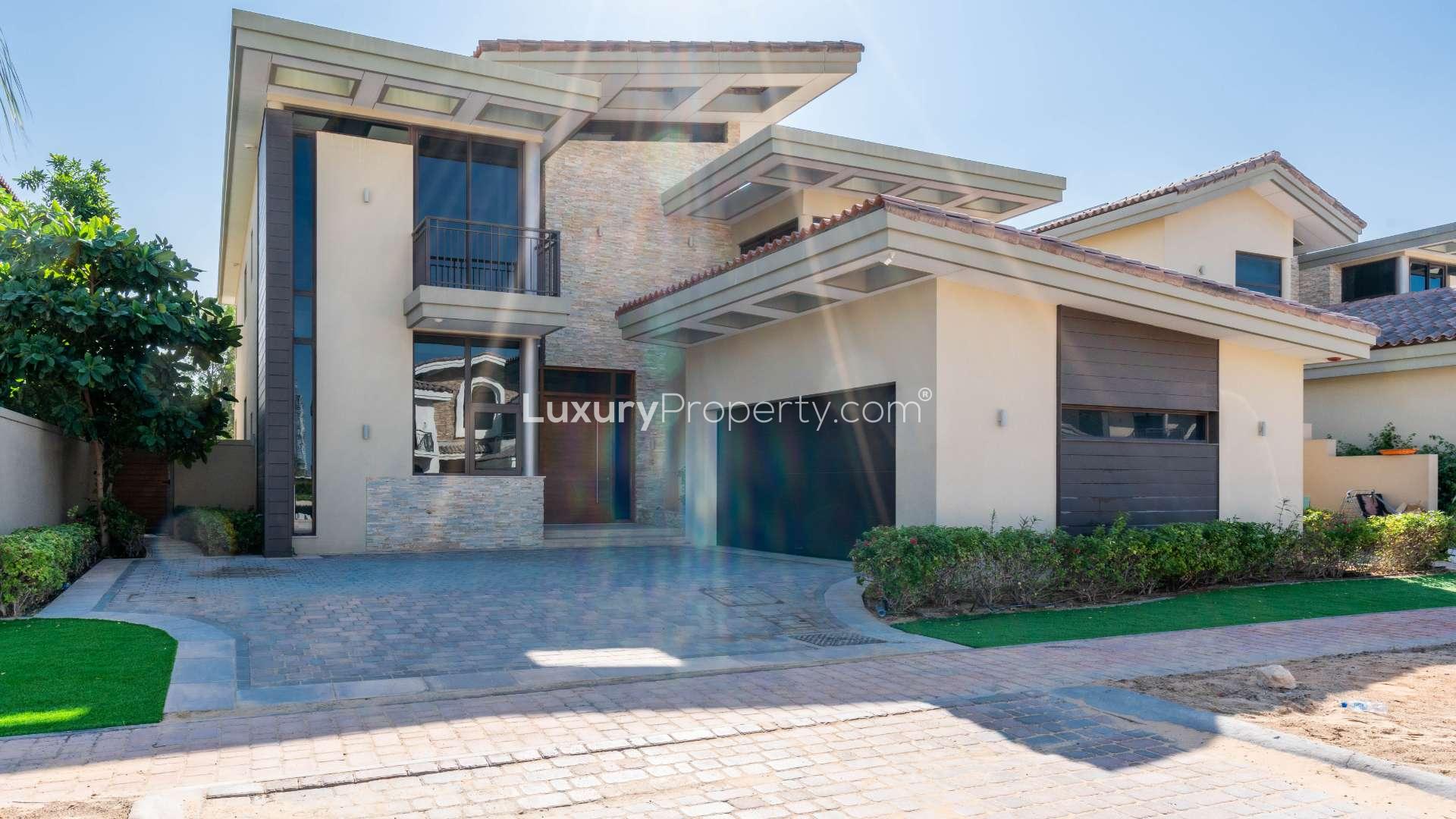 Spacious villa interior with large windows overlooking private pool in Jumeirah Golf Estates