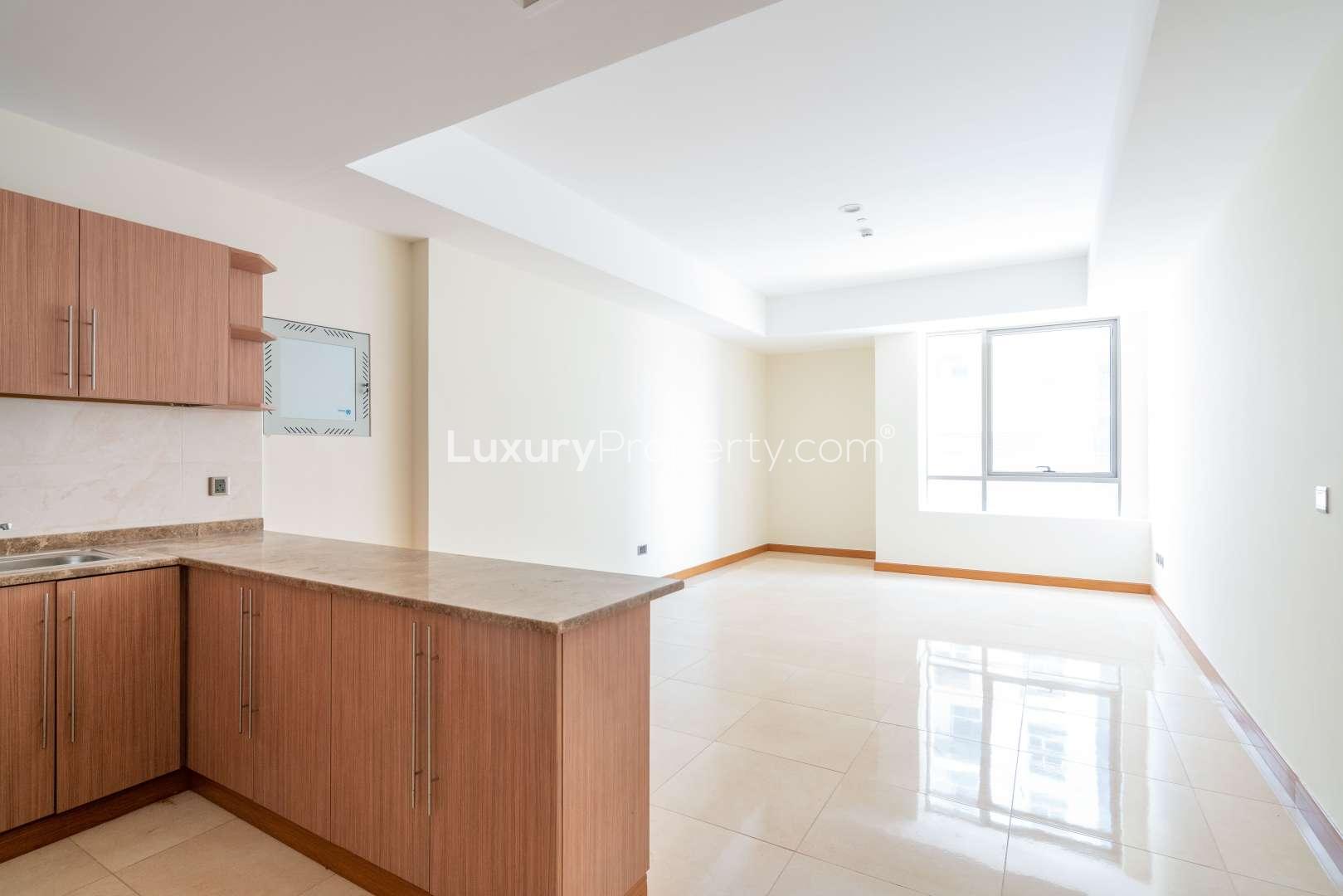 Spacious open-plan living area in Al Murad Tower, Al Barsha, with modern kitchen