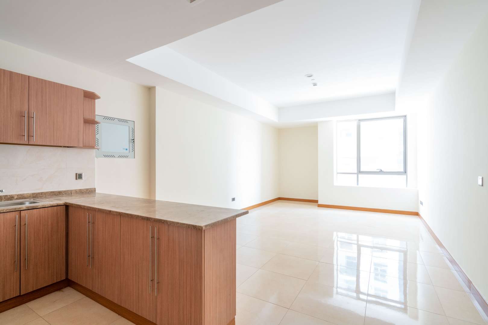 Spacious open-plan living area in Al Murad Tower, Al Barsha, with modern kitchen