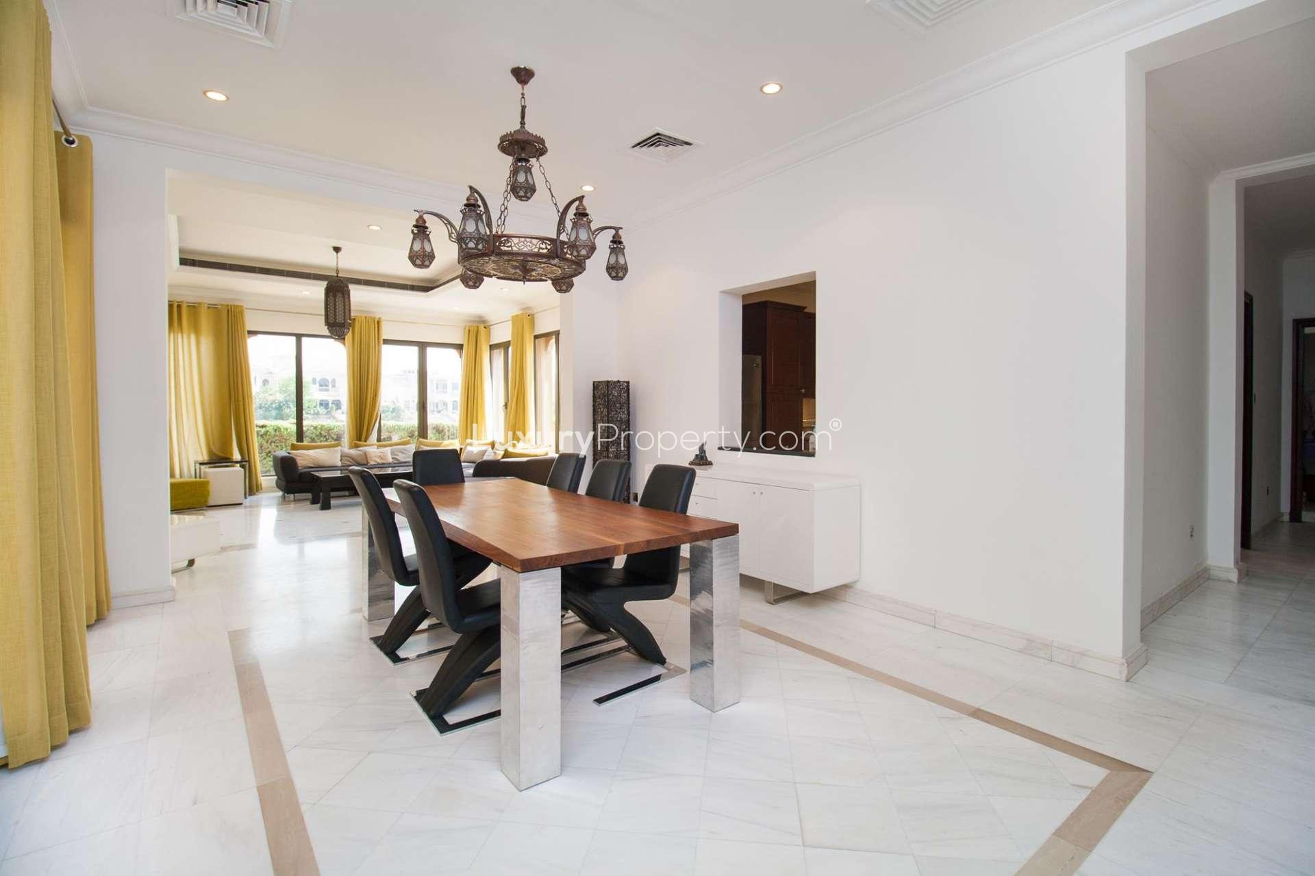 Luxurious living room in 6-bed villa, Palm Jumeirah, with large windows and elegant decor