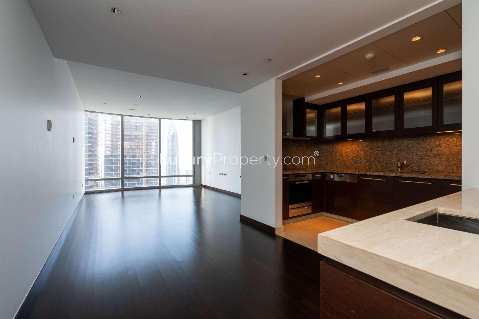 "Stunning view of Burj Khalifa and Dubai Fountain in Downtown Dubai, sunny day.",Modern kitchen and living area in 1-bedroom apartment, Burj Khalifa, Downtown Dubai for rent