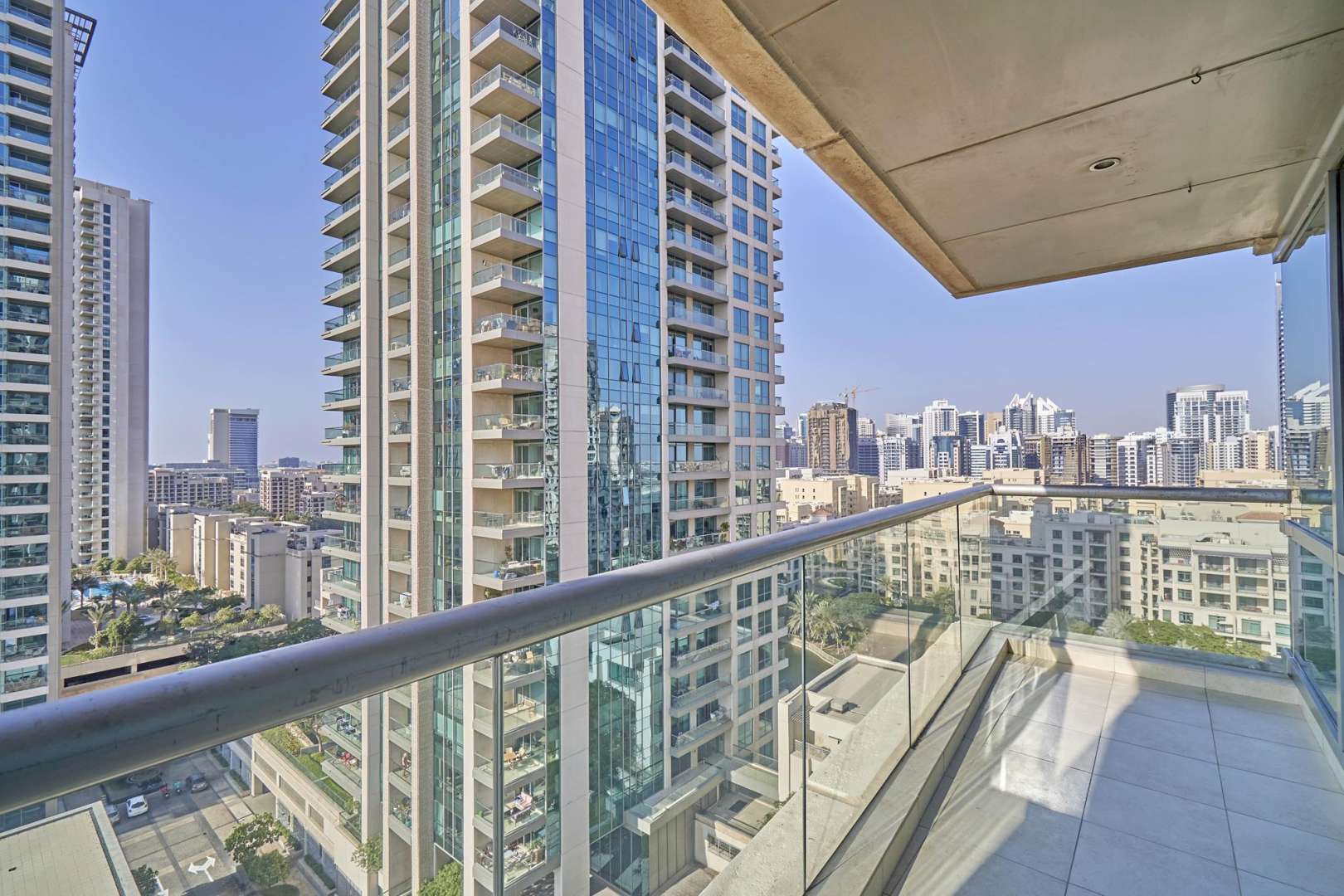 "Bright living room with city view in upgraded two-bedroom apartment, The Fairways, The Views.",Upgraded two-bedroom apartment balcony view in The Fairways, The Views, Dubai