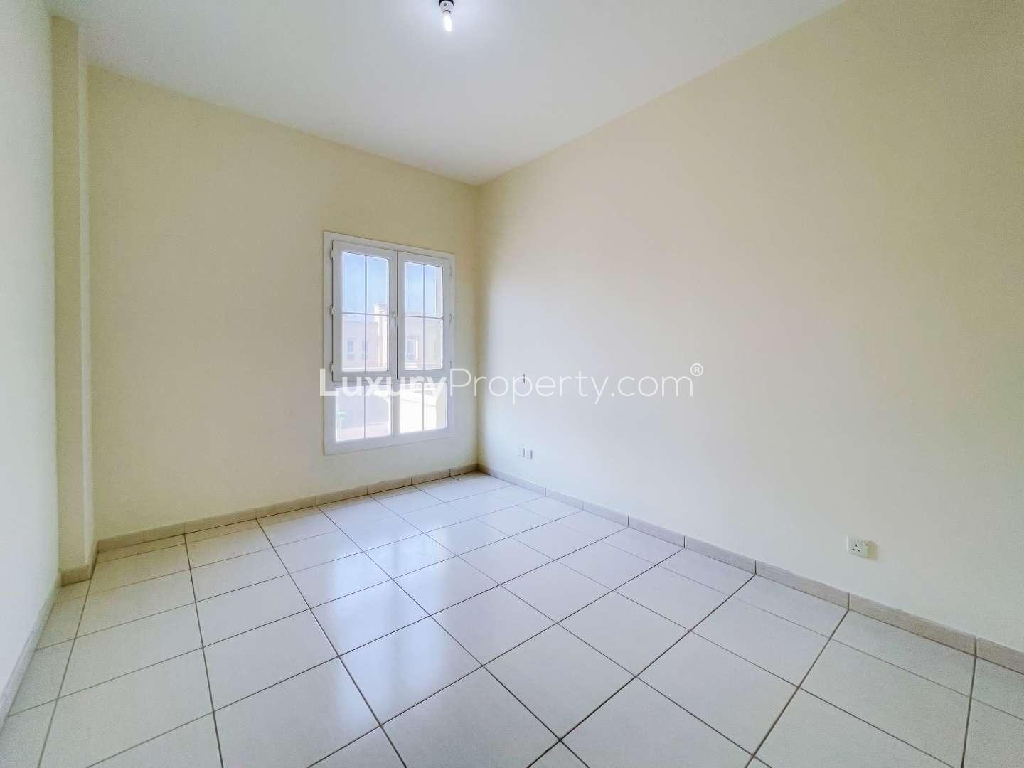 Spacious 3-bedroom villa exterior with carport in The Springs, Emirates Living community