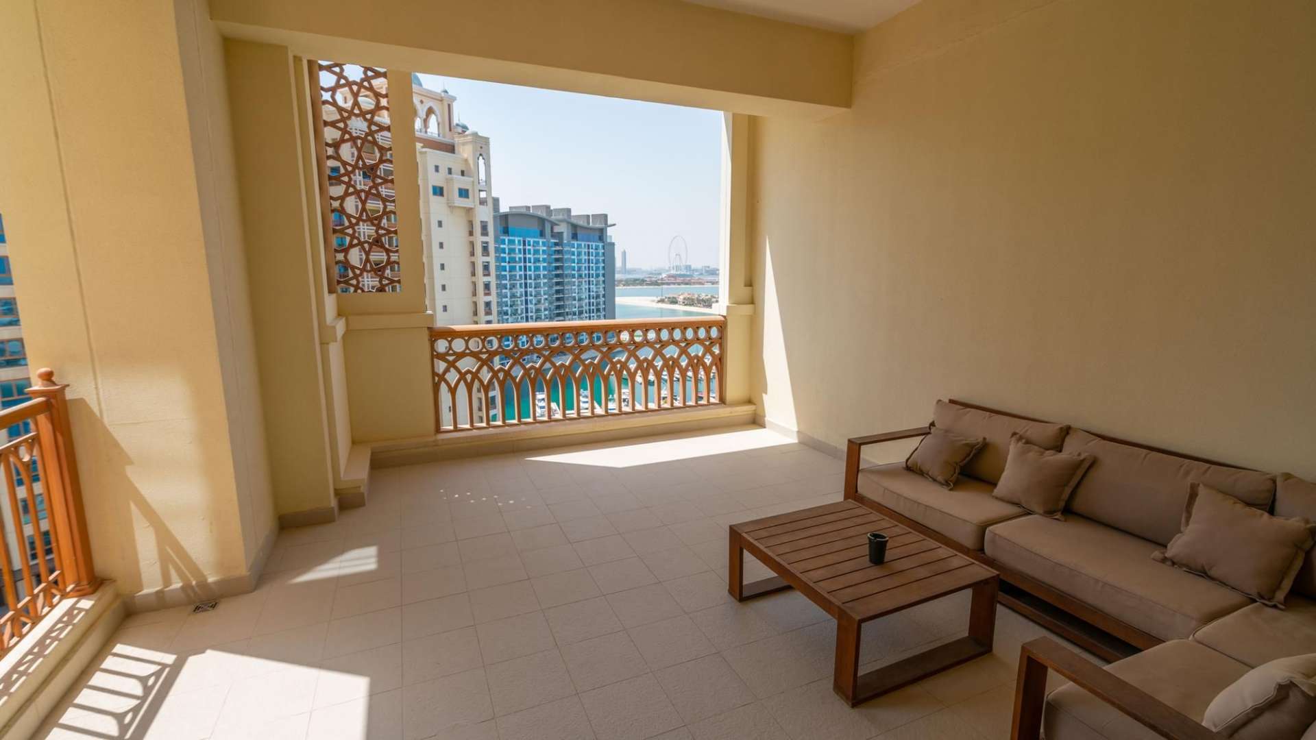 "Modern bathroom and wooden closet in Palm Jumeirah apartment for rent, Marina Residences.",Furnished balcony with sea view in Palm Jumeirah apartment for rent, Marina Residences