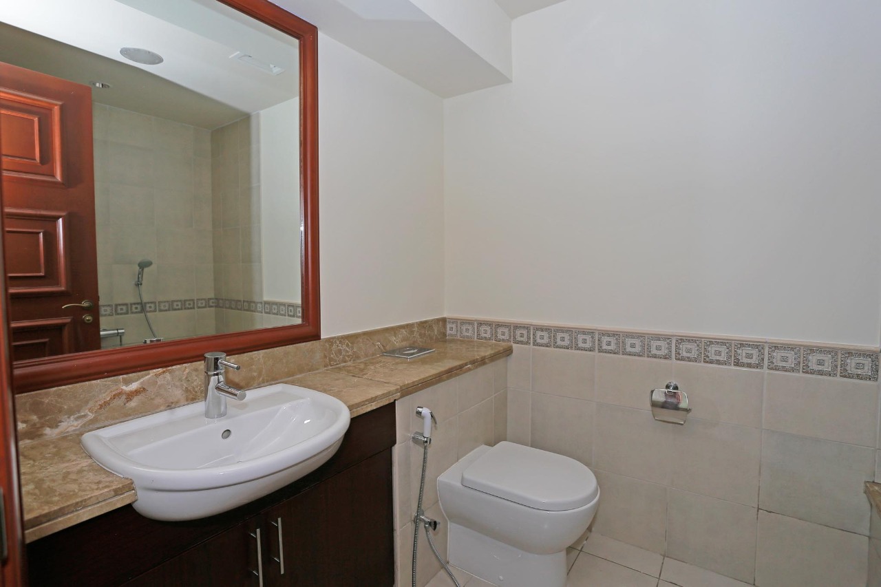 Empty room with built-in wooden wardrobes in Golden Mile apartment, Palm Jumeirah