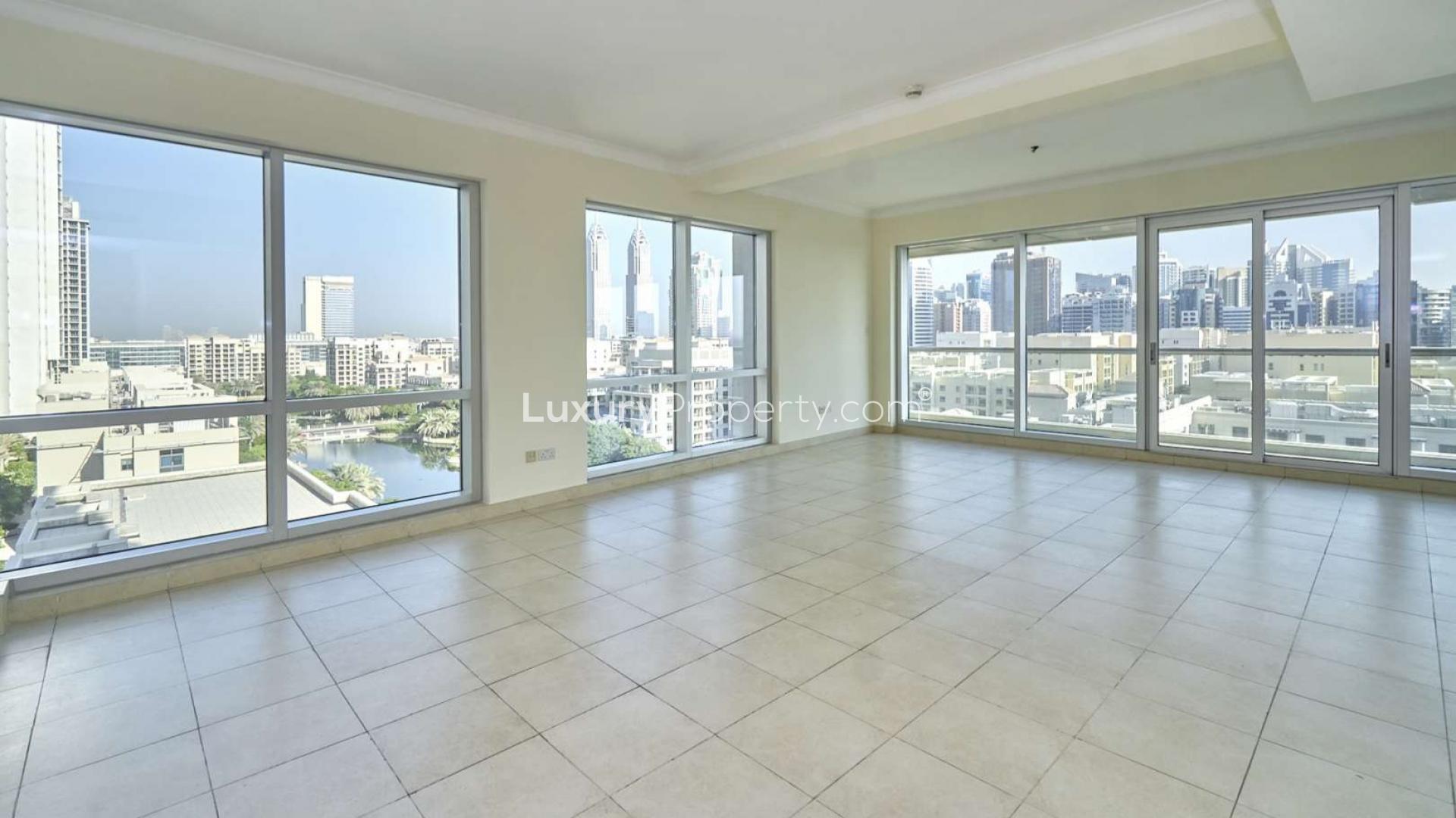Spacious apartment interior with large window offering golf and lake views, The Fairways