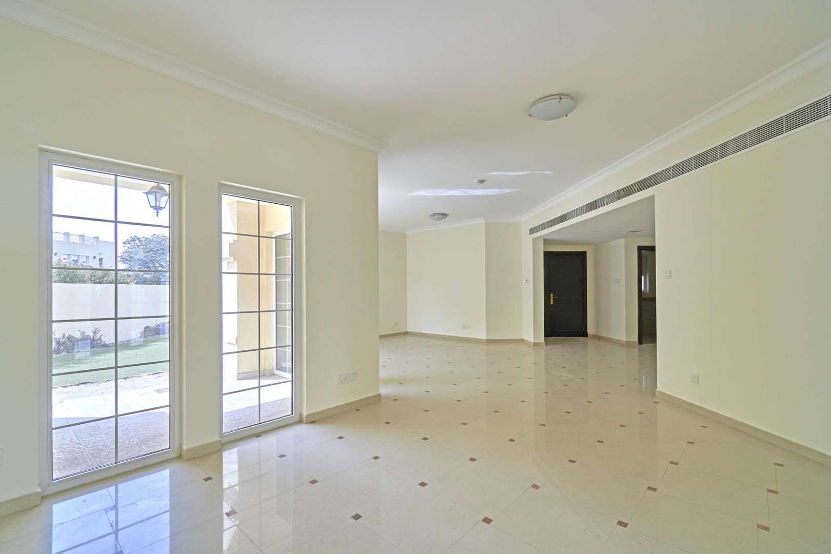 Spacious 4-bedroom townhouse exterior in Layan Community, Dubai, with lush greenery