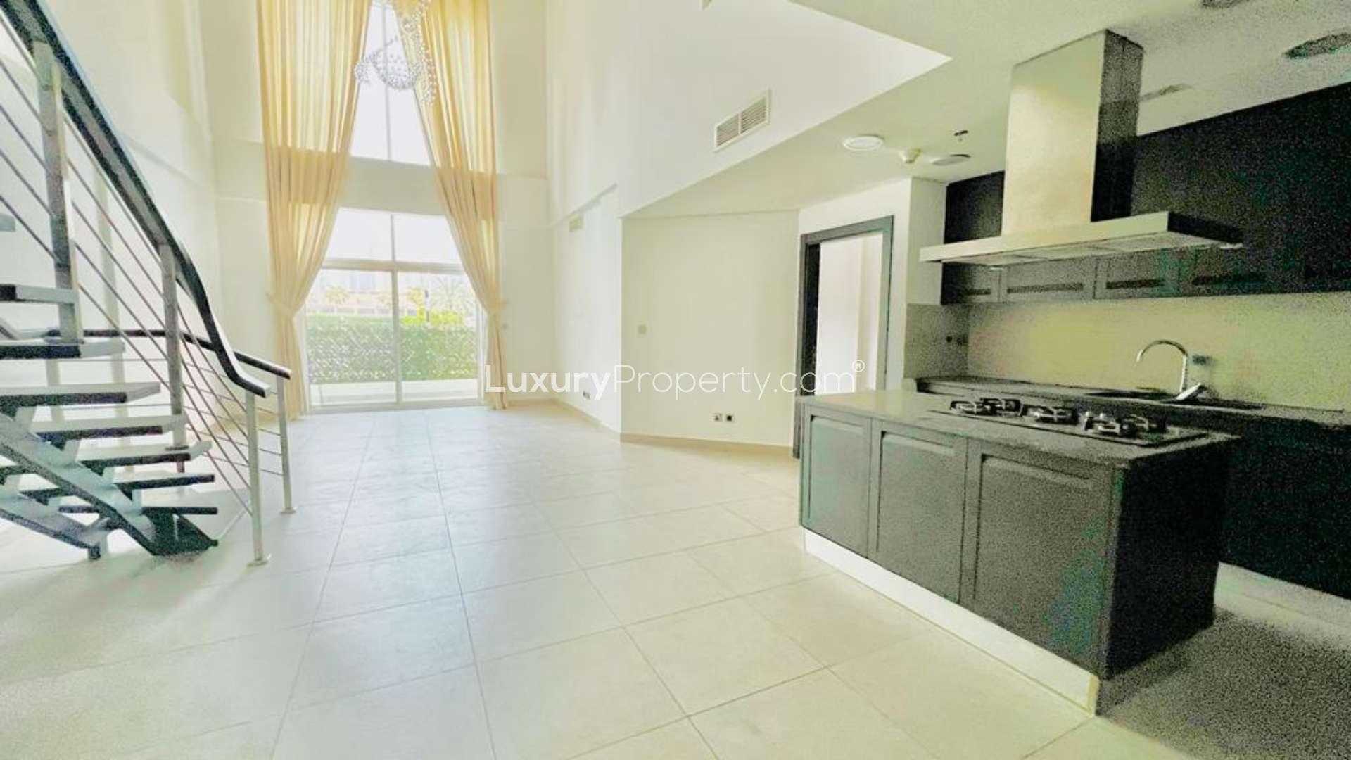 "Modern apartment building in Jumeirah Heights, Cluster E, available for rent, exterior view.",Modern open-plan kitchen and living area in Jumeirah Heights duplex apartment for rent