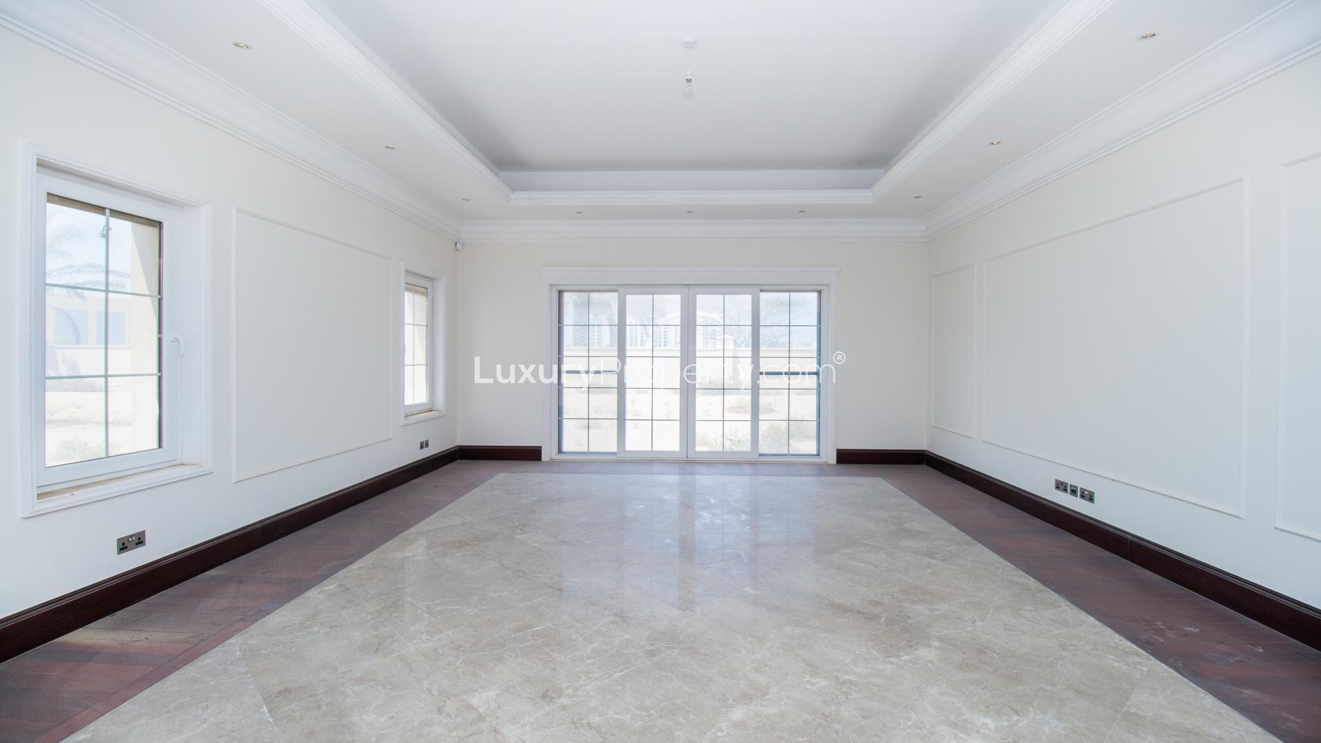 Spacious living room with large windows in Arabian Ranches Polo Homes villa for rent