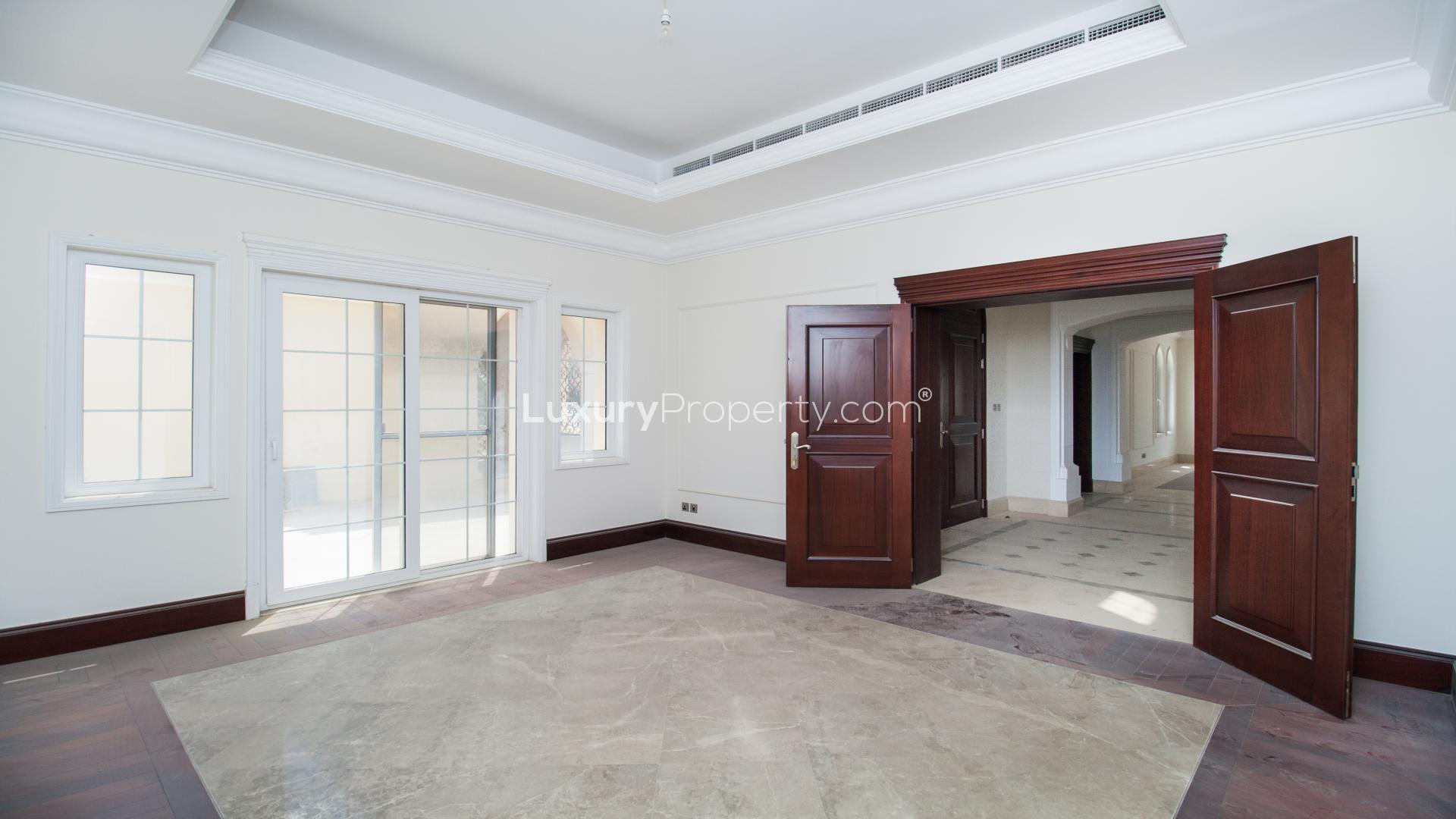 Spacious interior of luxury villa in Polo Homes, Arabian Ranches, with elegant wooden doors