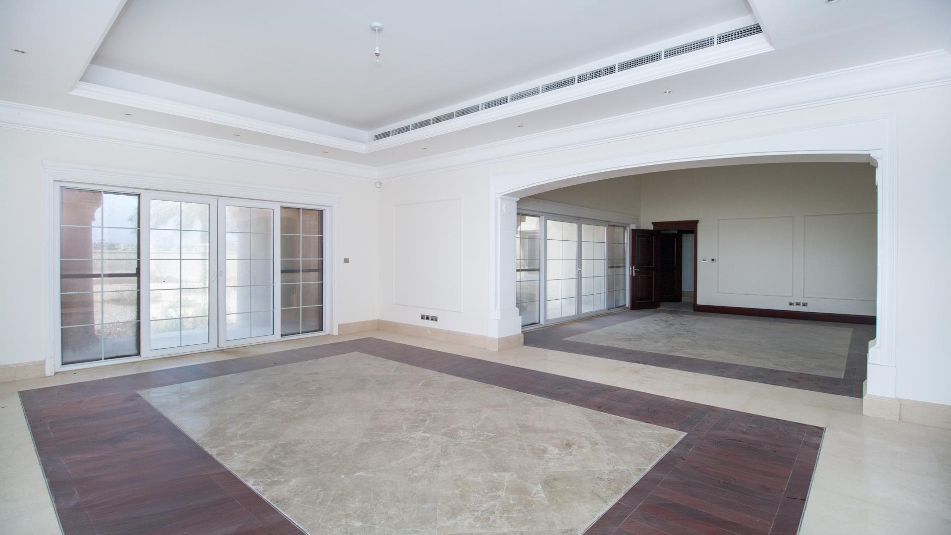 Spacious living area in Polo Homes villa, Arabian Ranches, with large windows and elegant flooring