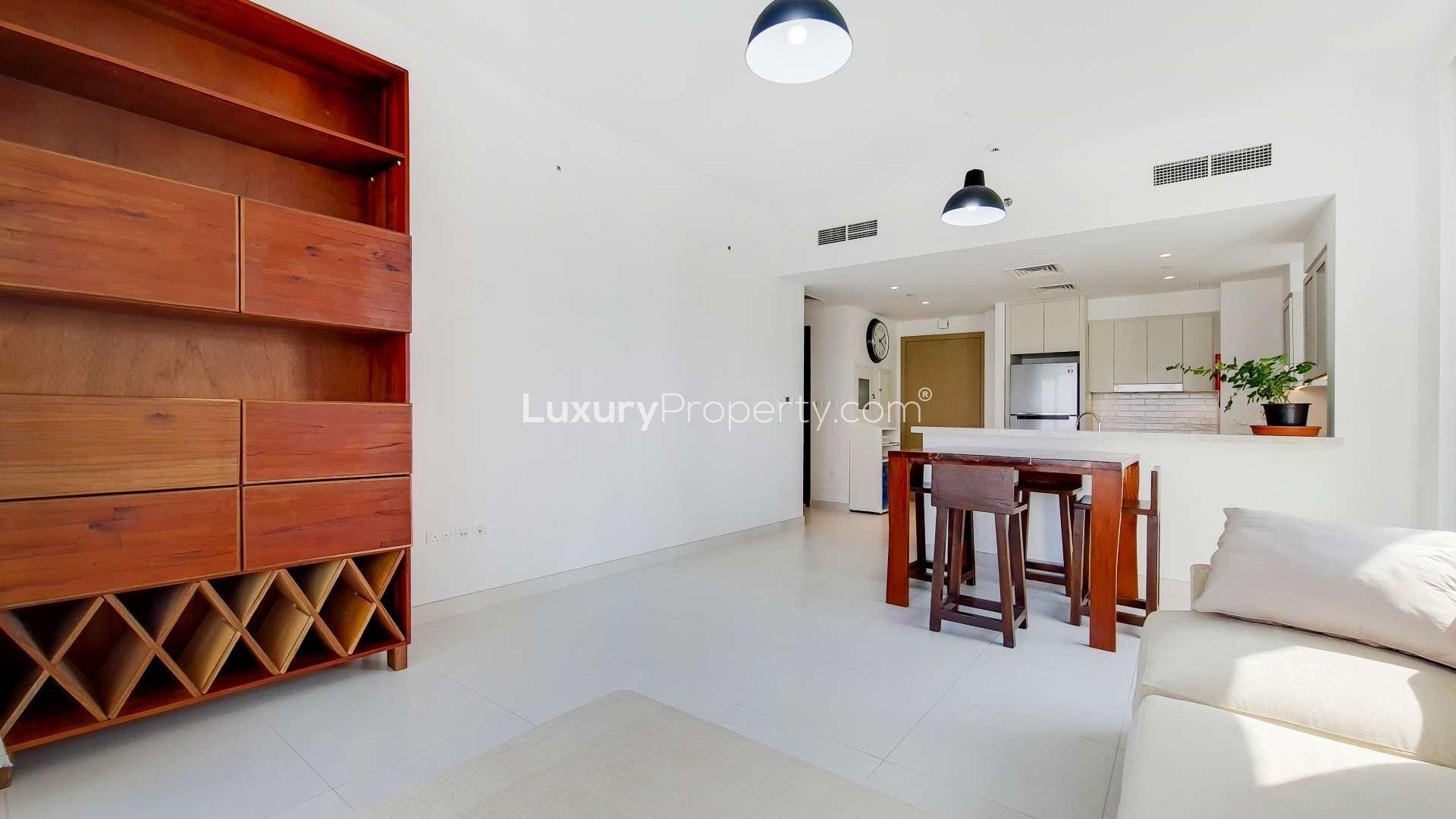 Mid-floor apartment living room with creek view, modern furniture, and large windows