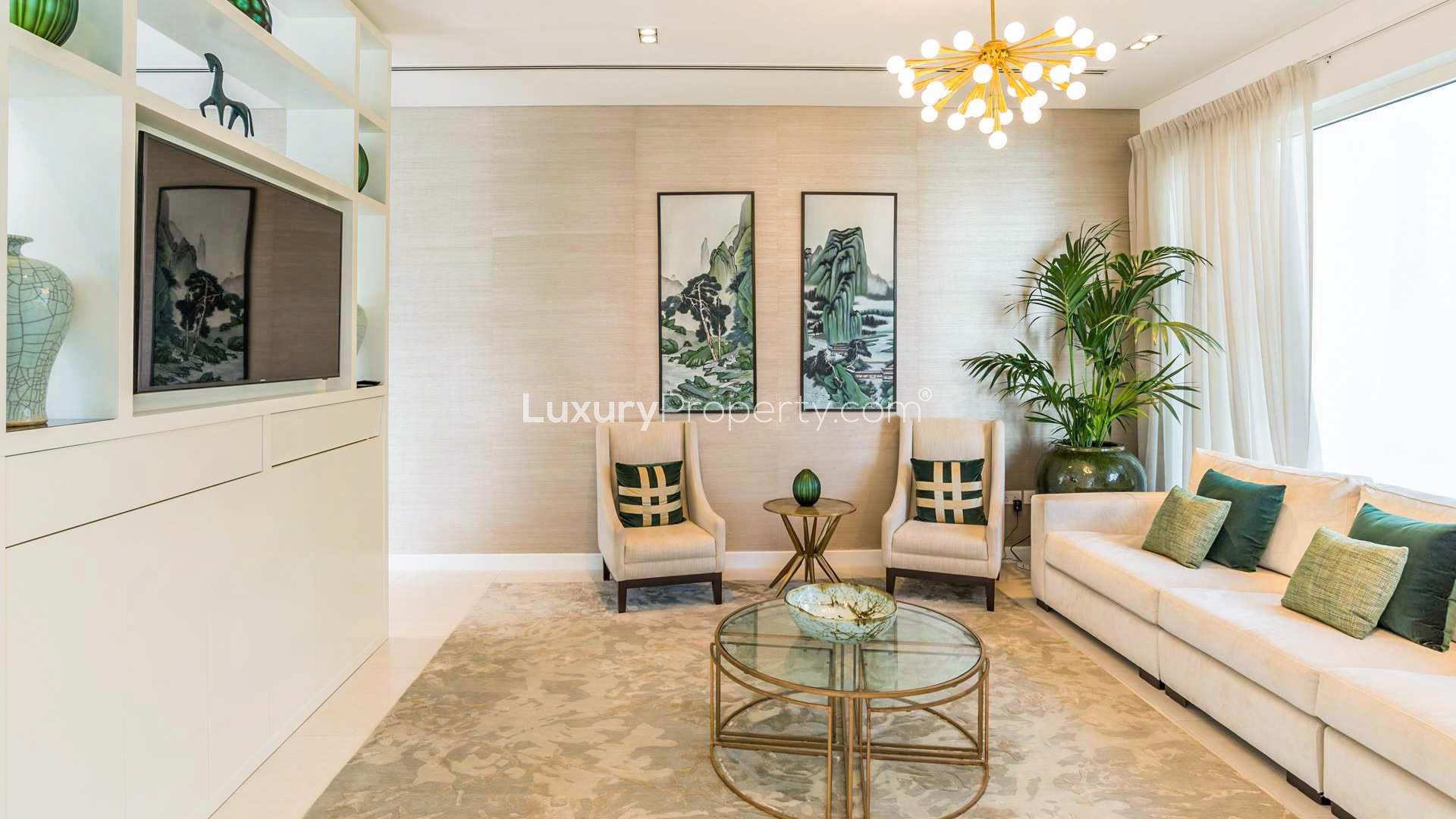 Luxurious living room in five-bedroom villa, The Nest, Al Barari, featuring modern decor