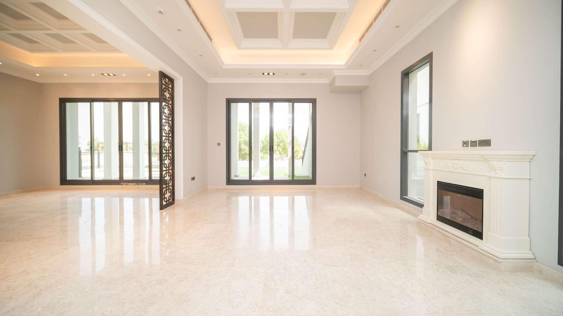 "Wildflower Villa private pool with scenic golf course views, Jumeirah Golf Estates Earth community.",Spacious living room in Wildflower Villa, Jumeirah Golf Estates, with fireplace and large windows