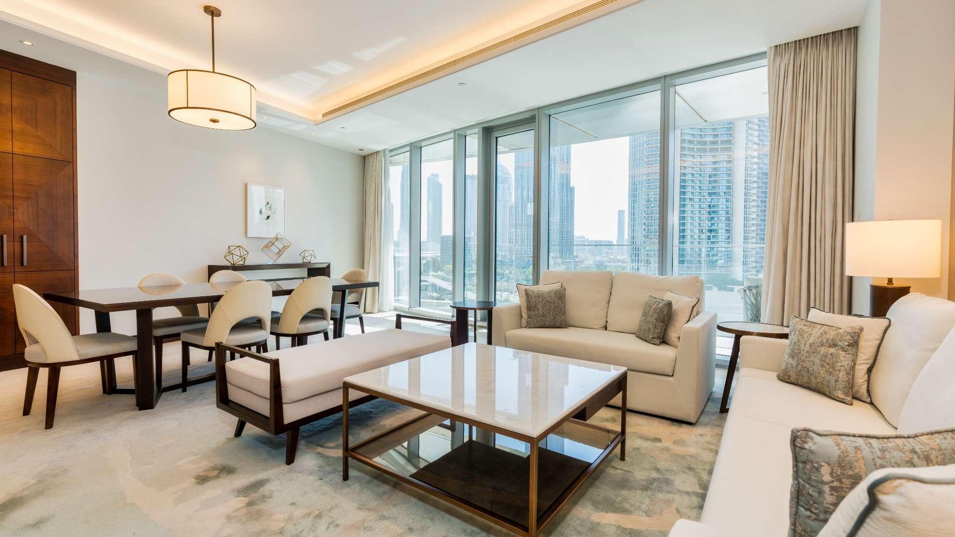 "Full Burj Khalifa view from modern apartment in The Address Sky View Towers, Downtown Dubai.",Modern living room in Downtown Dubai apartment with Burj Khalifa view, elegant furnishings