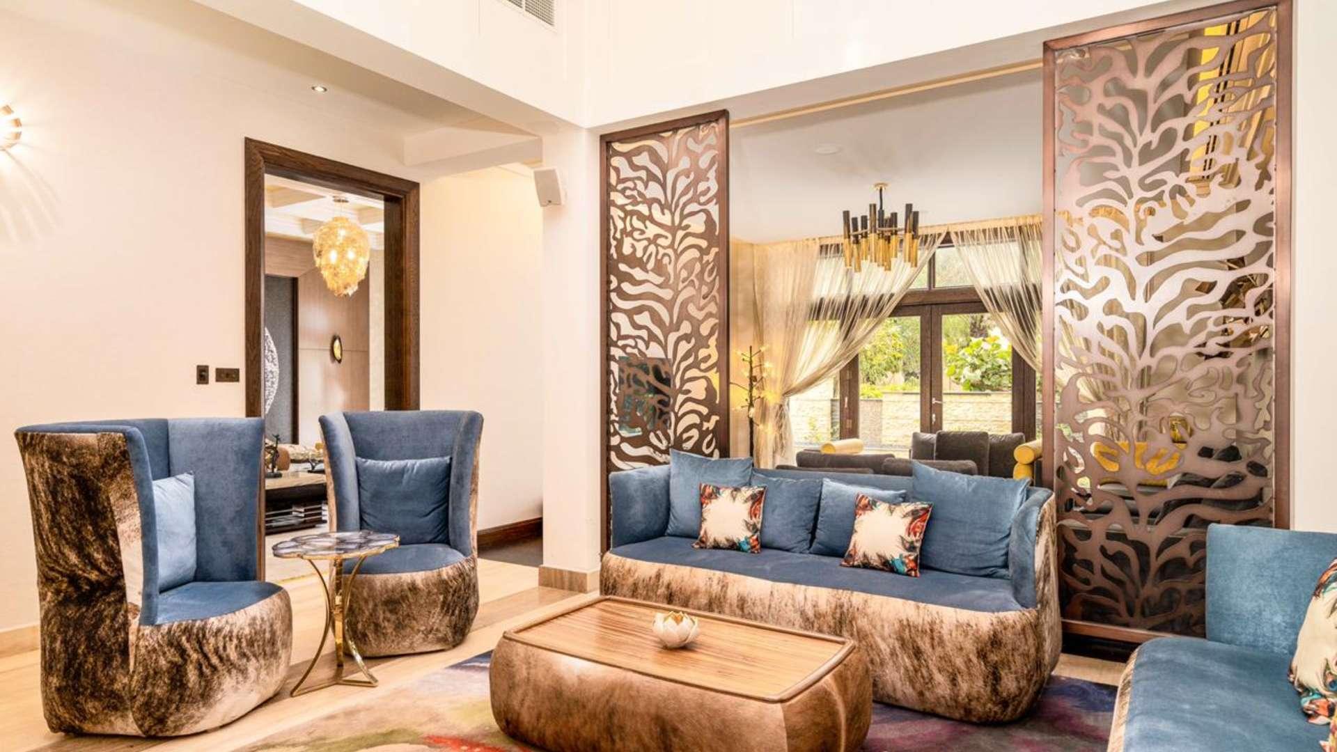 Modern living room in 6-bedroom villa, Al Barari, featuring stylish decor and elegant design