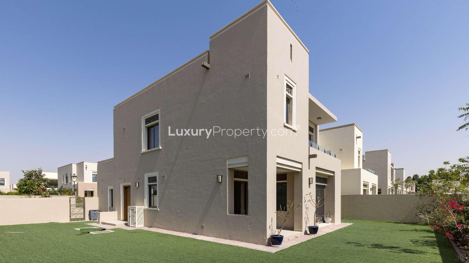 Bright living area with large windows, overlooking garden in Azalea, Arabian Ranches 2 villa