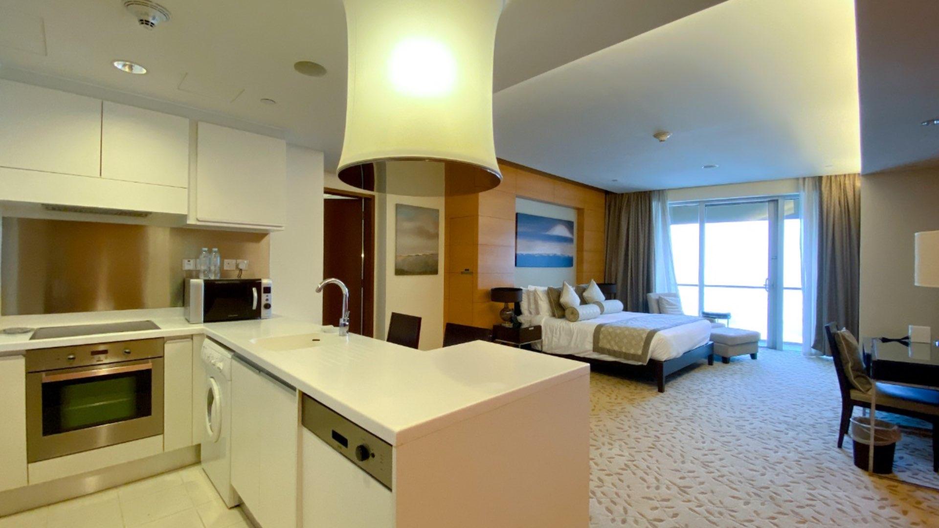 View from balcony,Overall view,Kitchen
,Kitchen,Pool view,"High-rise apartment building in The Address Dubai Mall, Downtown Dubai, available for rent.",Studio apartment interior with city view, Downtown Dubai, The Address Dubai Mall
