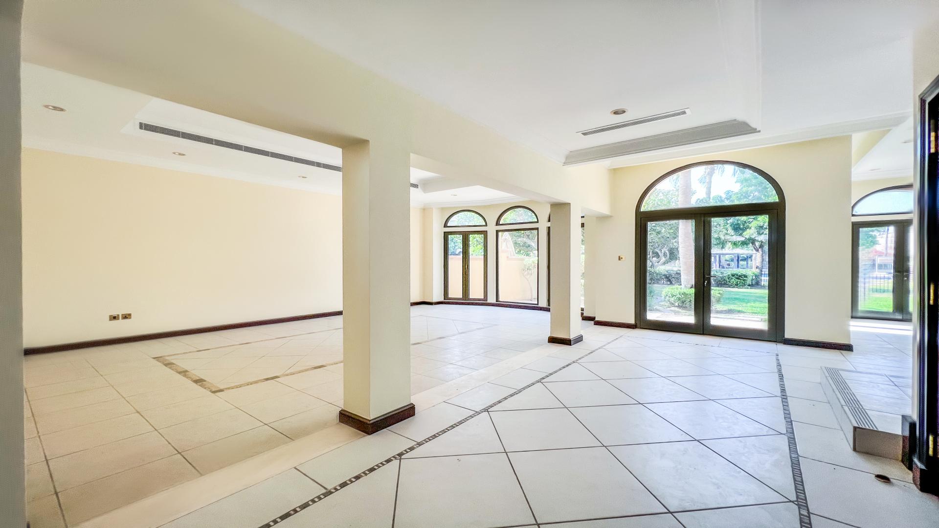 Palm Jumeirah Canal Cove Villas lush garden with pool and waterfront view