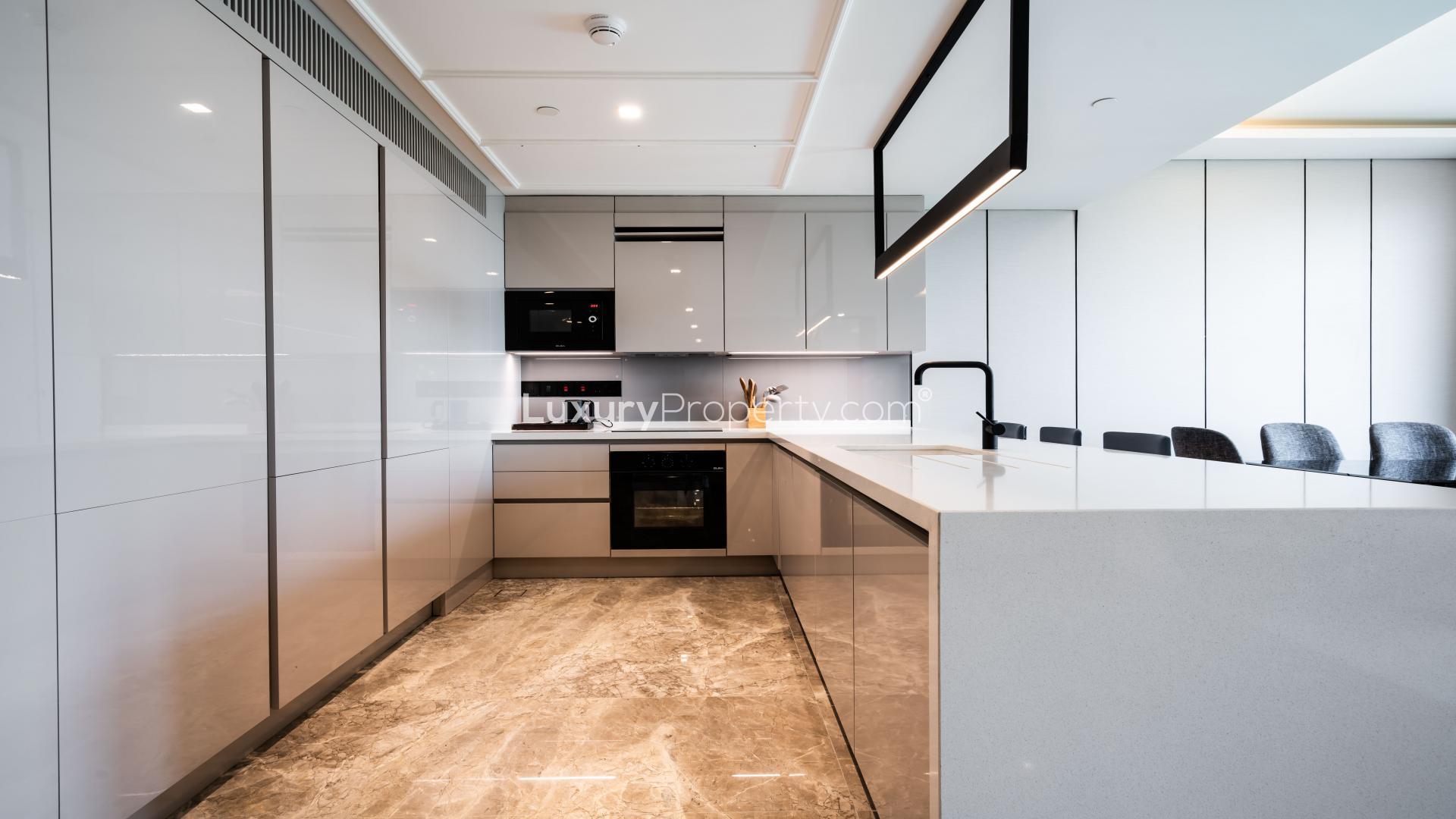 Luxurious open-plan living area in 1-bedroom apartment, Caesars Bluewaters Dubai, modern design