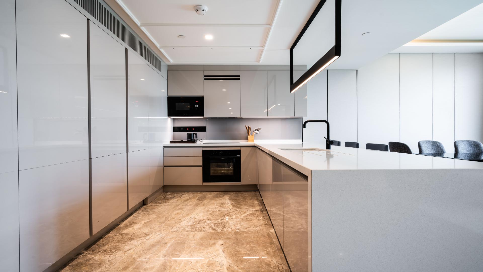 Luxurious open-plan living area in 1-bedroom apartment, Caesars Bluewaters Dubai, modern design