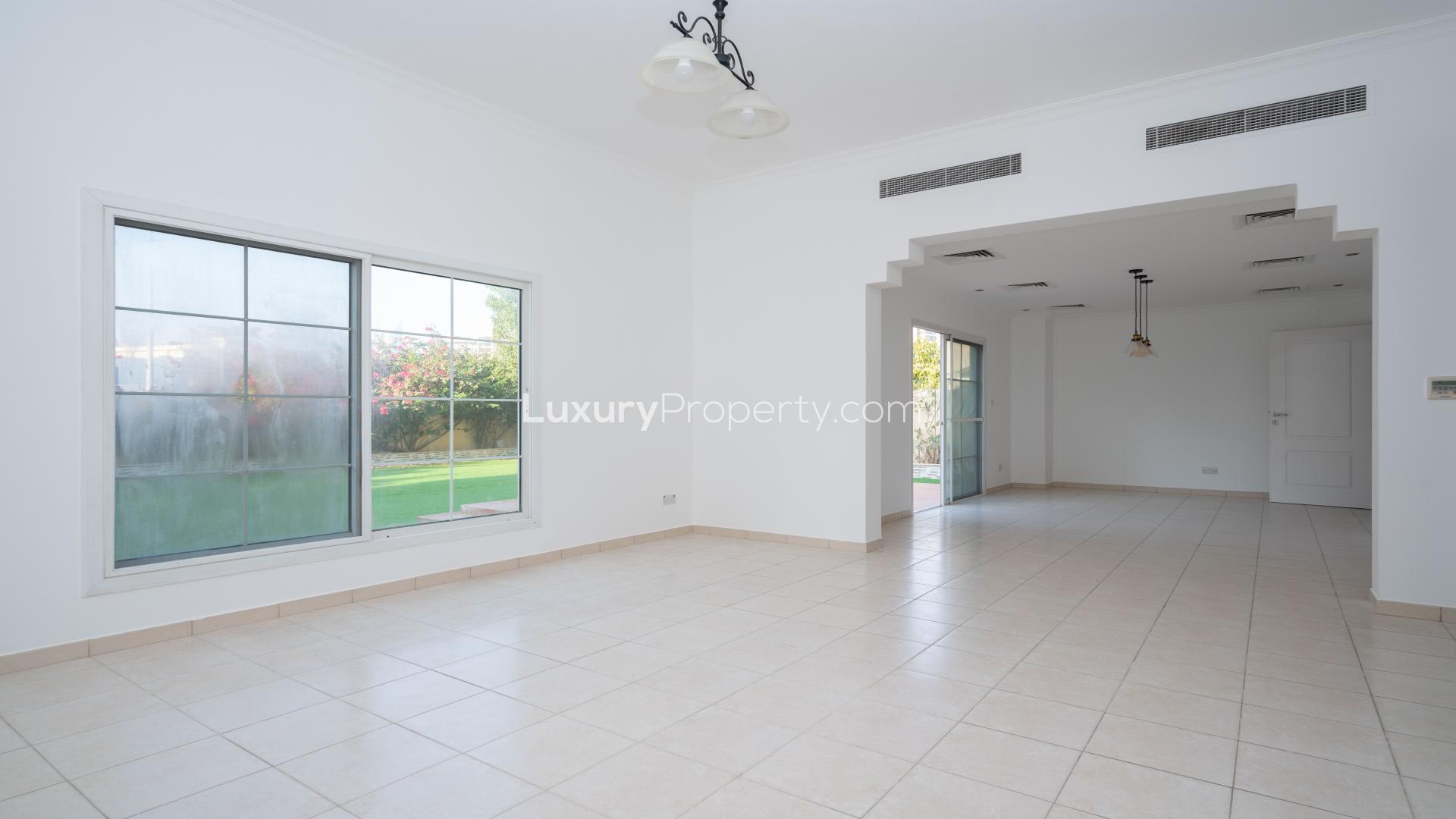 "Spacious villa interior with garden view in Meadows 9, available for rent. Ref: LP16042.",Spacious villa interior in Meadows 9 with tiled floors and modern kitchen, available for rent
