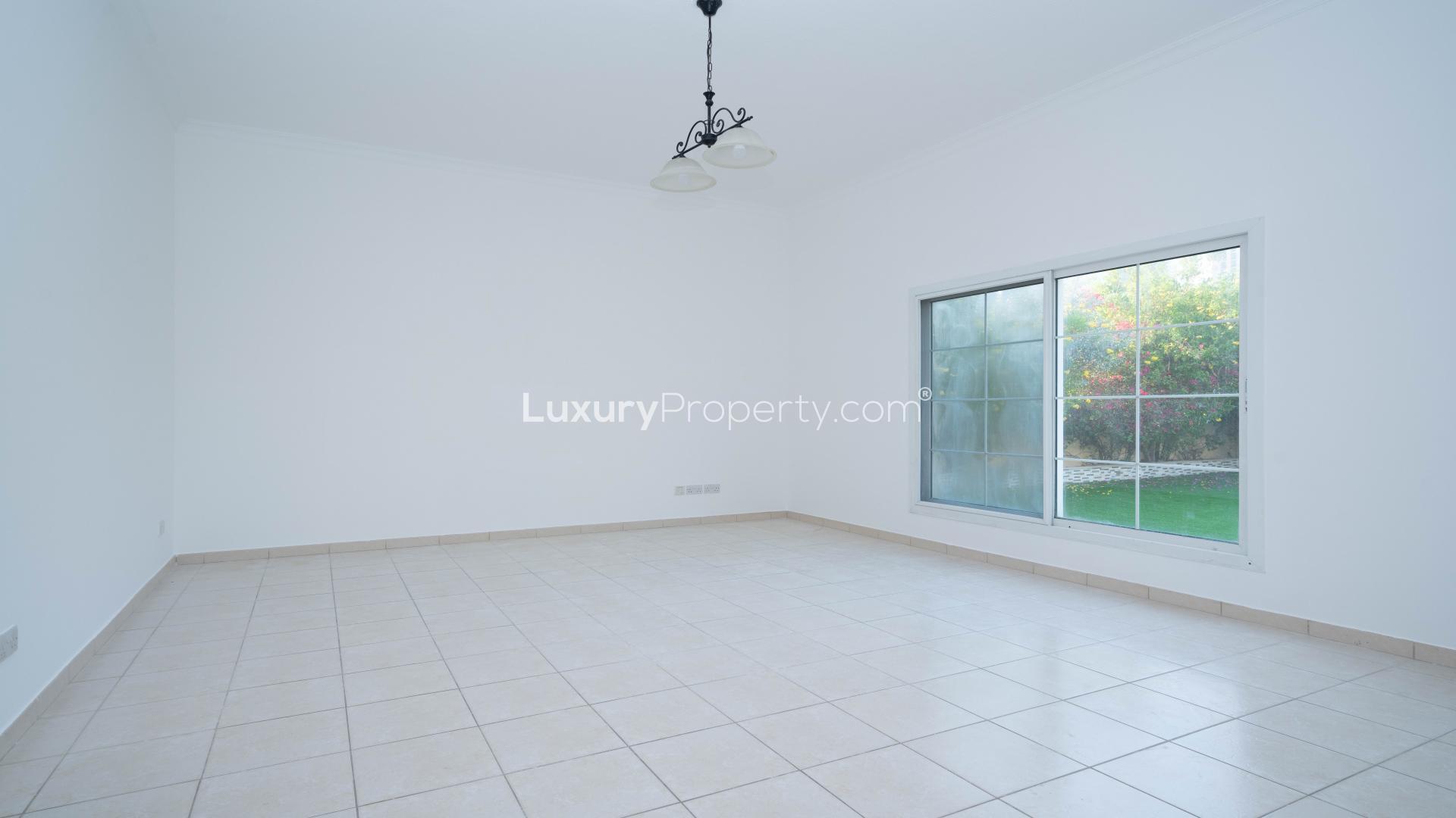 Empty room with tiled floor and garden view in Meadows 9 villa for rent