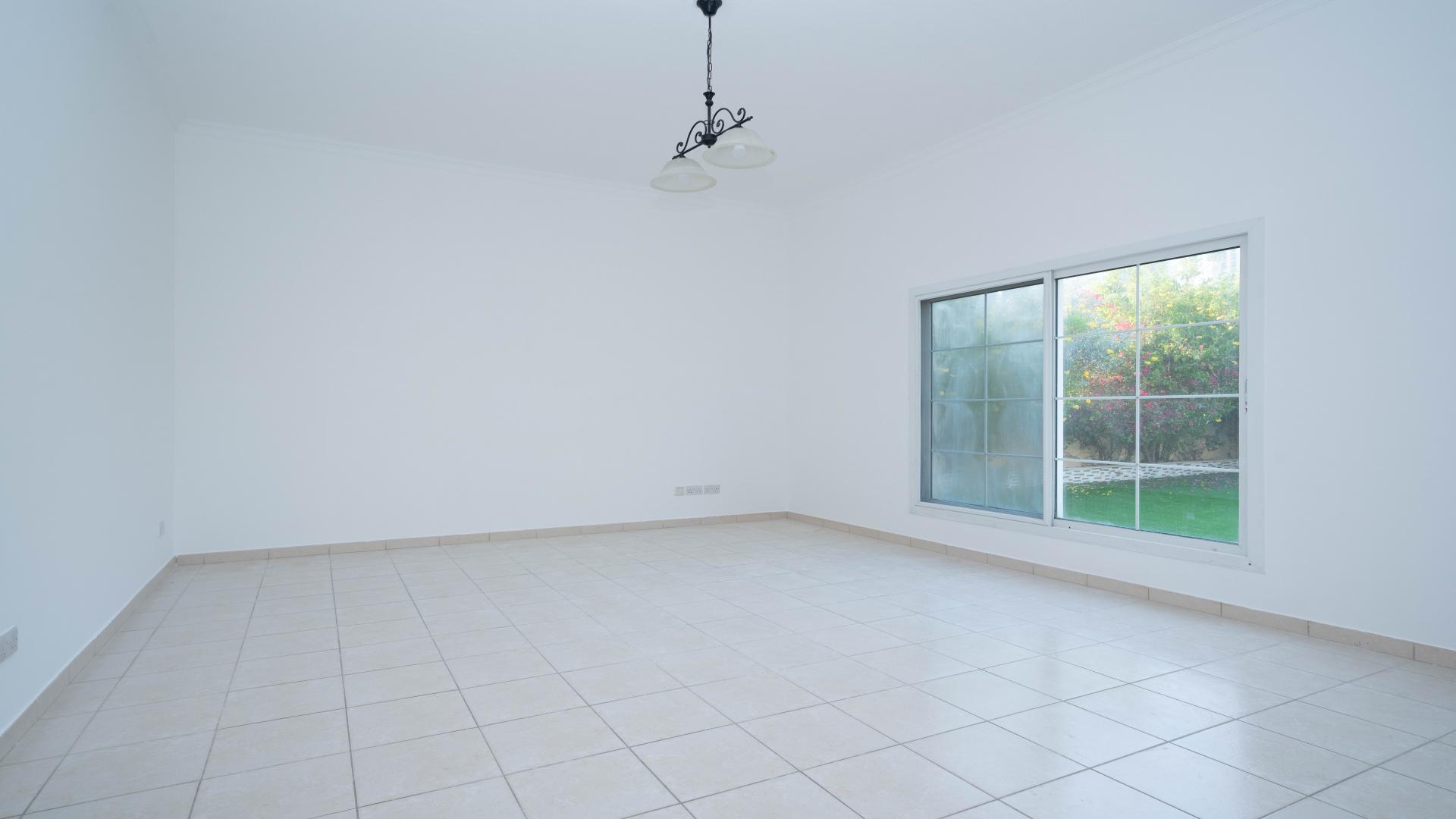 Empty room with tiled floor and garden view in Meadows 9 villa for rent