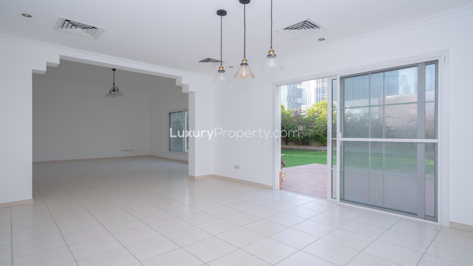 "Immaculate 4-bed villa with landscaped garden in Meadows 9, available for rent.",Bright villa interior with tiled floors and garden view in Meadows 9, available for rent