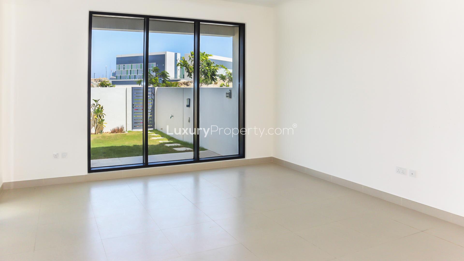 Modern townhouse exterior in Maple, Dubai Hills Estate with spacious parking area. Rent now