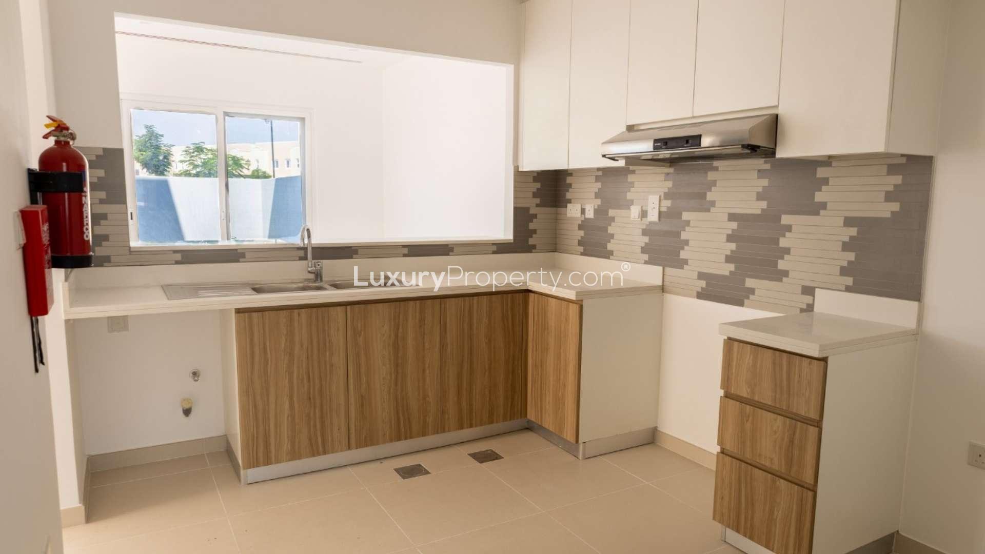 "Spacious living room in modern 3-bed townhouse, Villanova, Dubai Land, for rent.",Modern kitchen in brand new 3-bed townhouse for rent in Villanova, Dubai Land