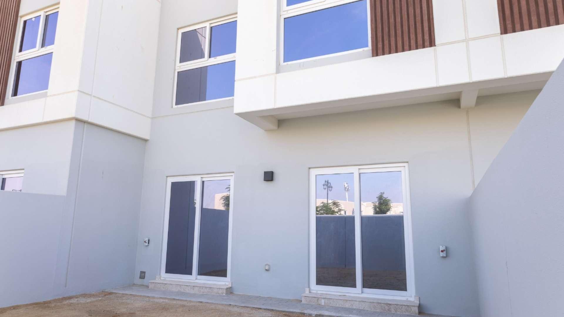 Brand new townhouse exterior with private garden in Villanova, Dubai Land for rent