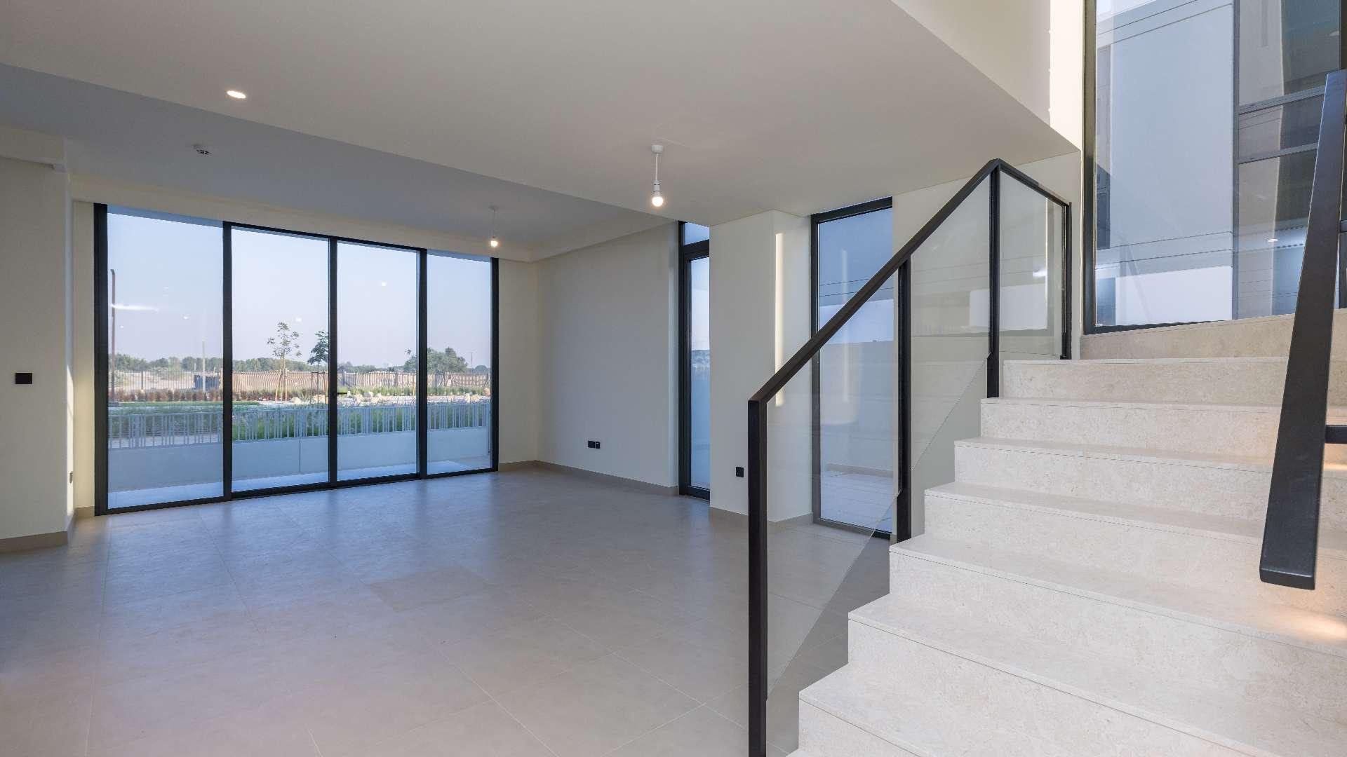 Modern villa exterior in Golf Grove, Dubai Hills Estate, with rooftop terrace and garden