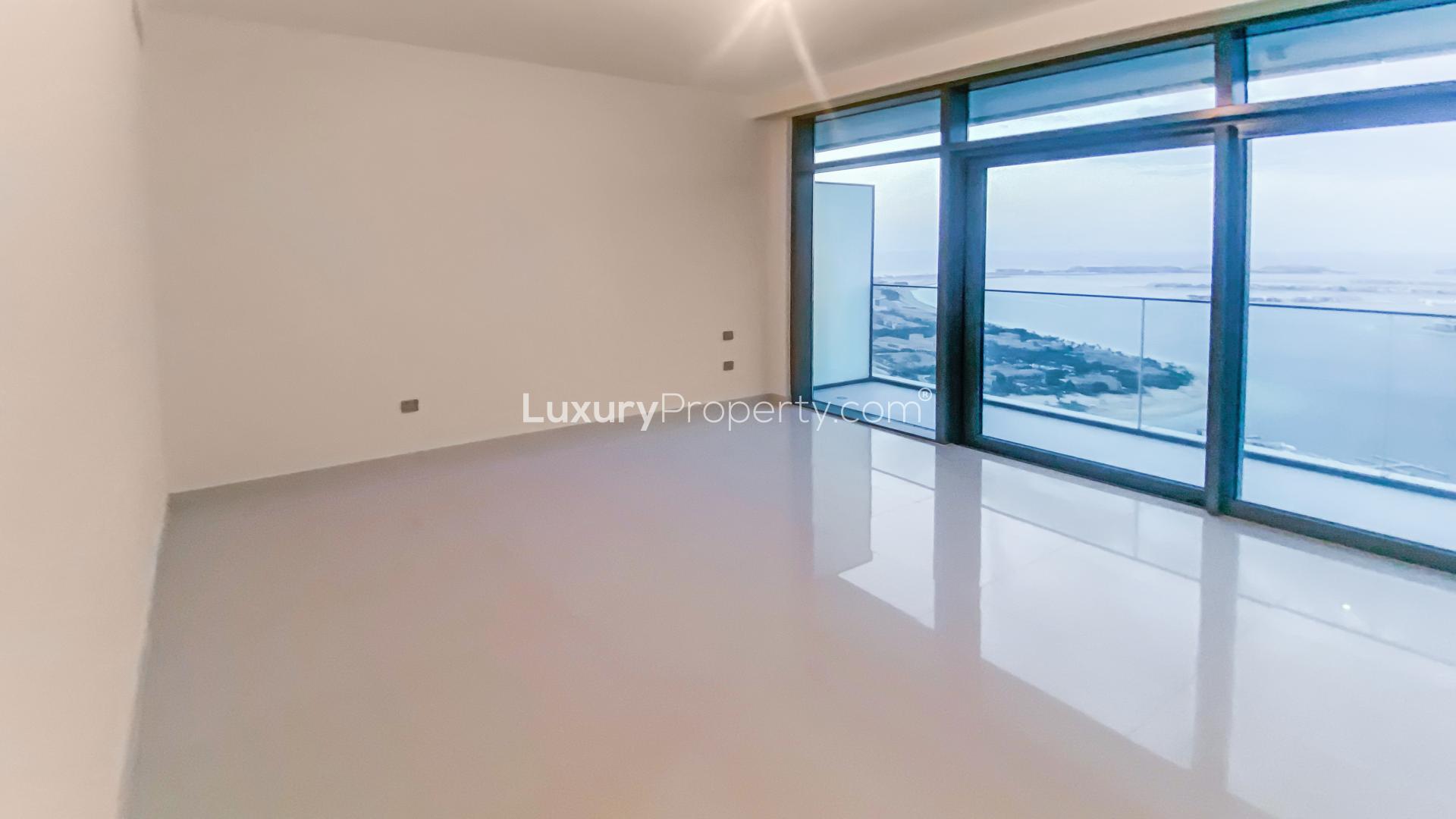 Modern kitchen with marble island in Emaar Beachfront apartment, Dubai Harbour