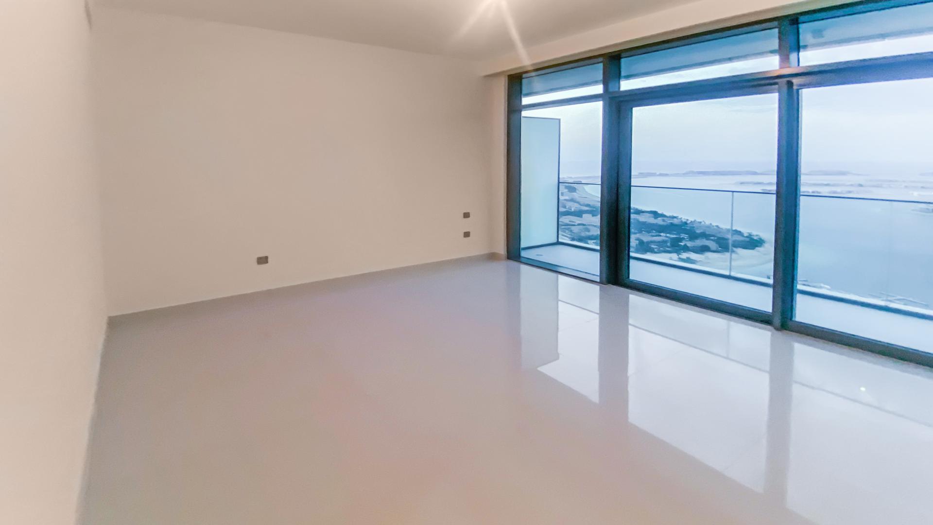 Modern kitchen with marble island in Emaar Beachfront apartment, Dubai Harbour