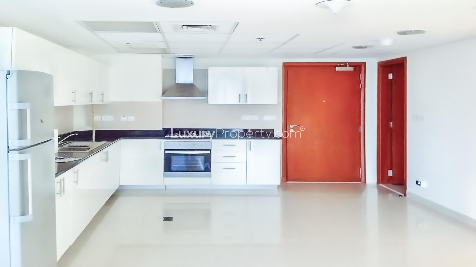 Empty modern apartment with DIFC skyline view through large geometric windows in Park Towers